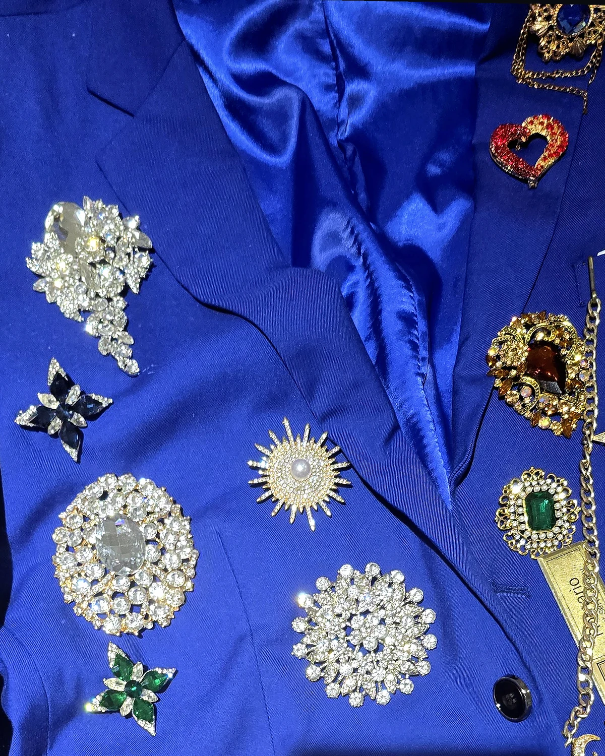Front crop of the royal-blue Wonder Suit jacket showing the original brooch placement across both lapels and sleeves.