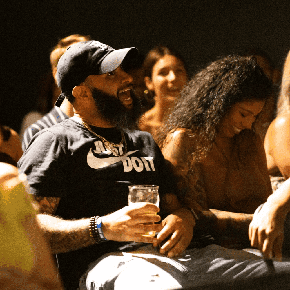 A man laughing at jokes at a St Pete Standup show