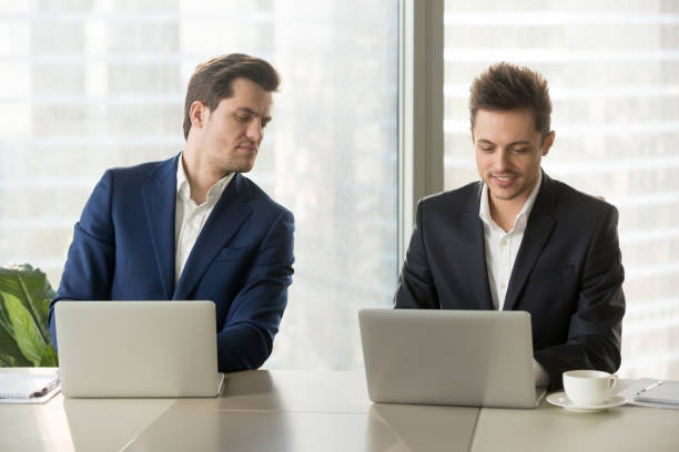 Man looking at someone's laptop screeen