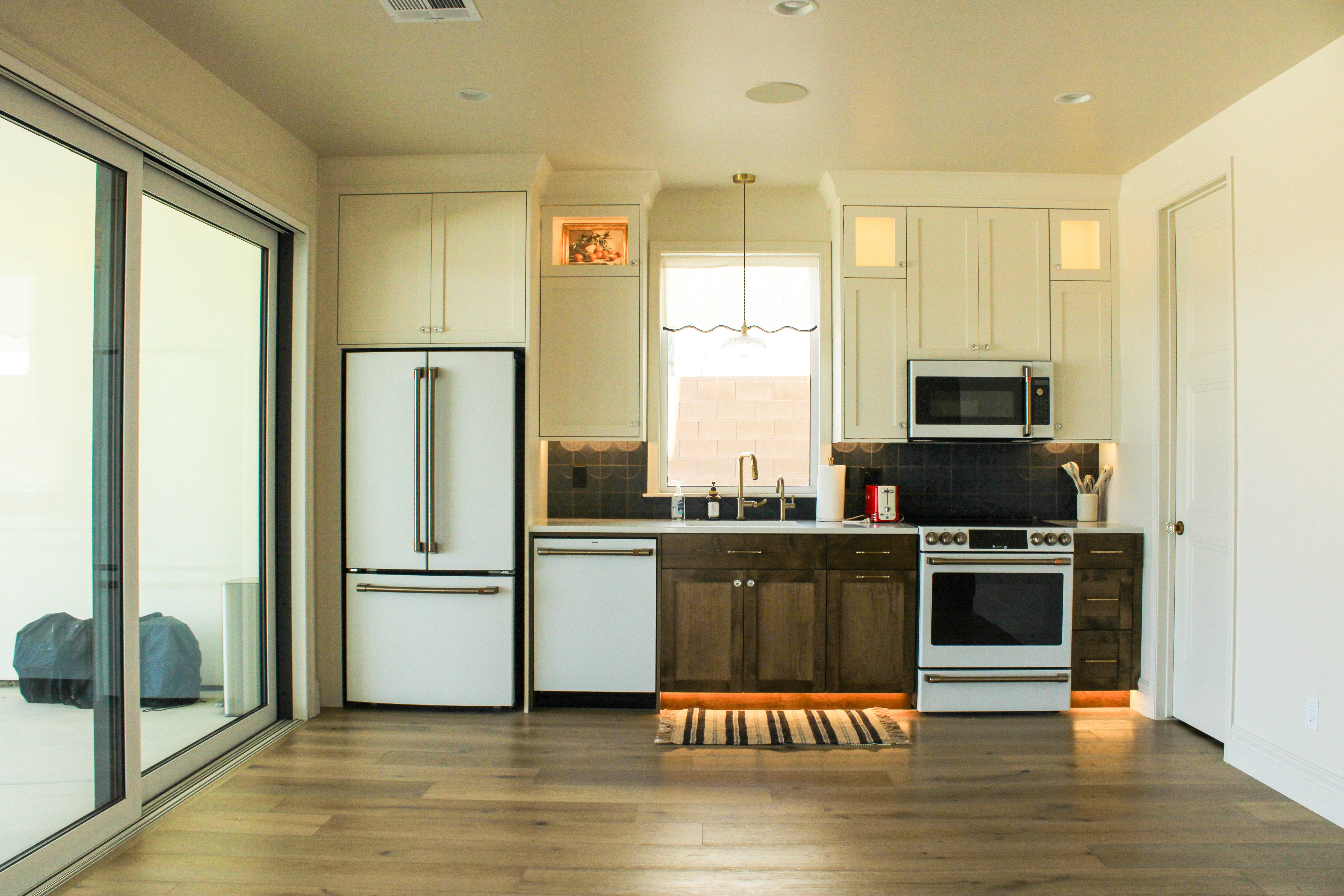 Downstairs kitchenette in a St. George, Utah custom home with two toned cabinets and ribbon lighting accents.