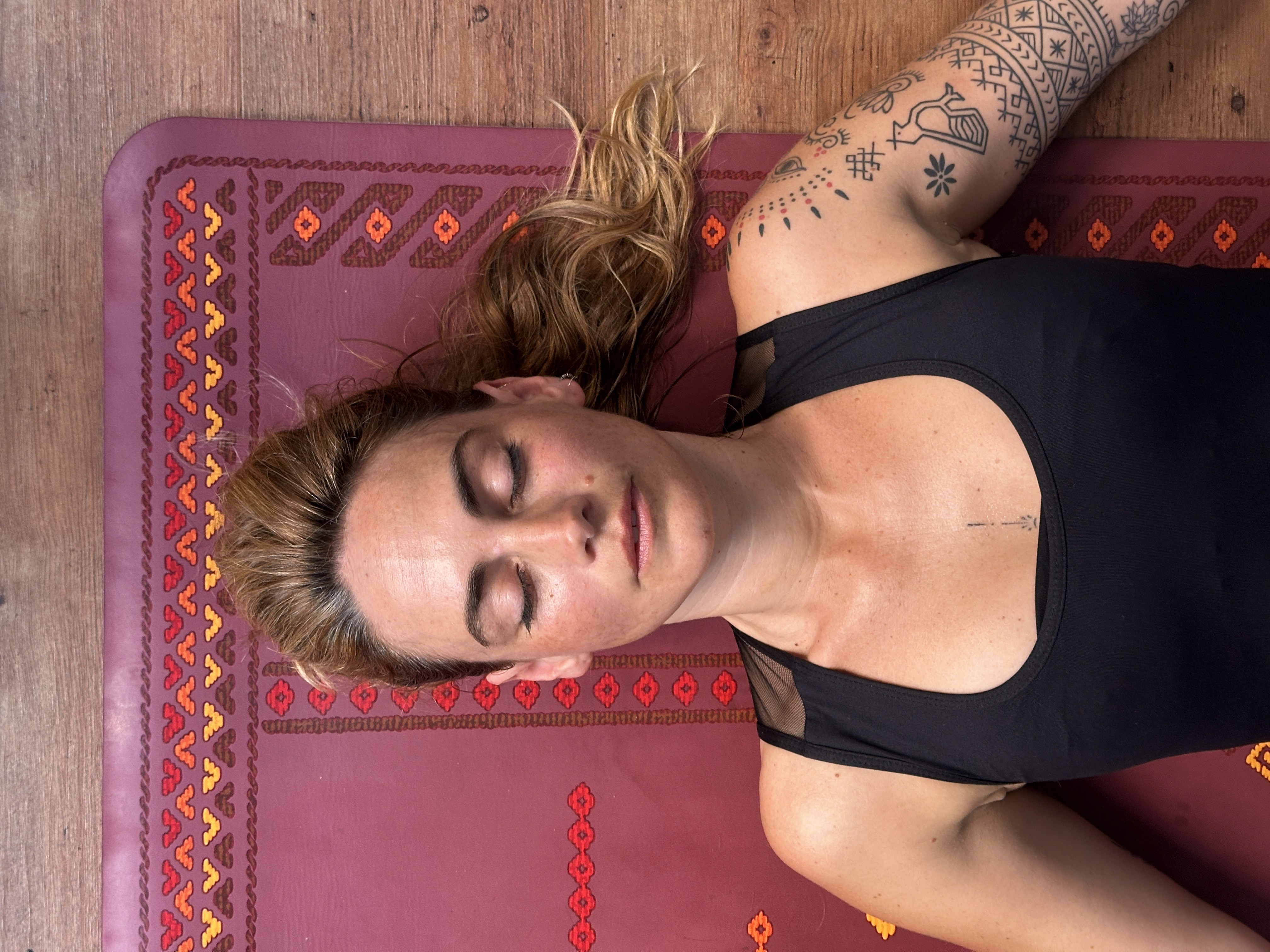 Close-up of a person meditating cross-legged indoors
