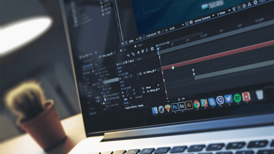 Laptop on a clean desk next to modern decor.