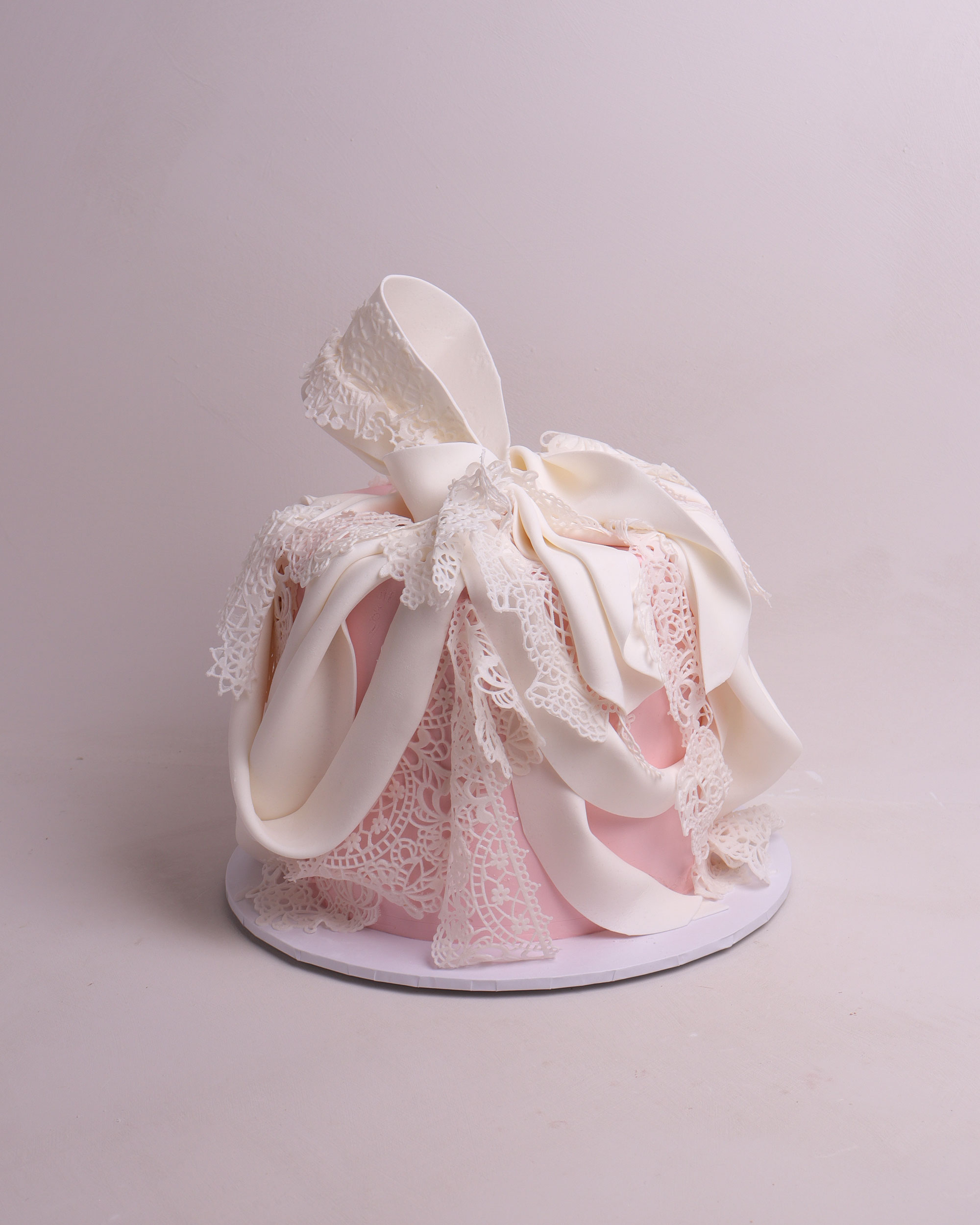 Bridal shower cake with edible lace and fondant draping.