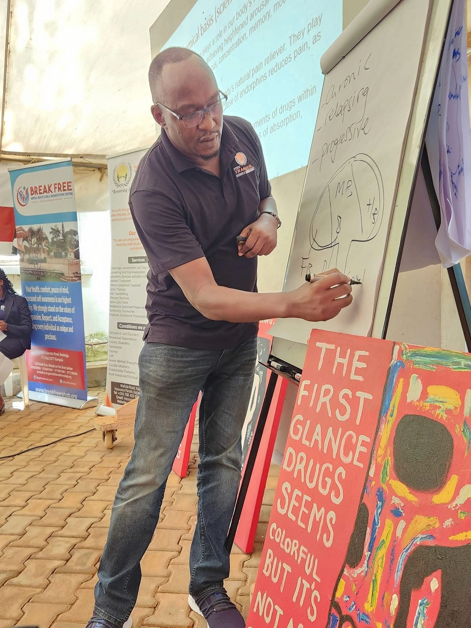 woman in black crew neck t-shirt wearing brown framed eyeglasses standing on rocky shore during