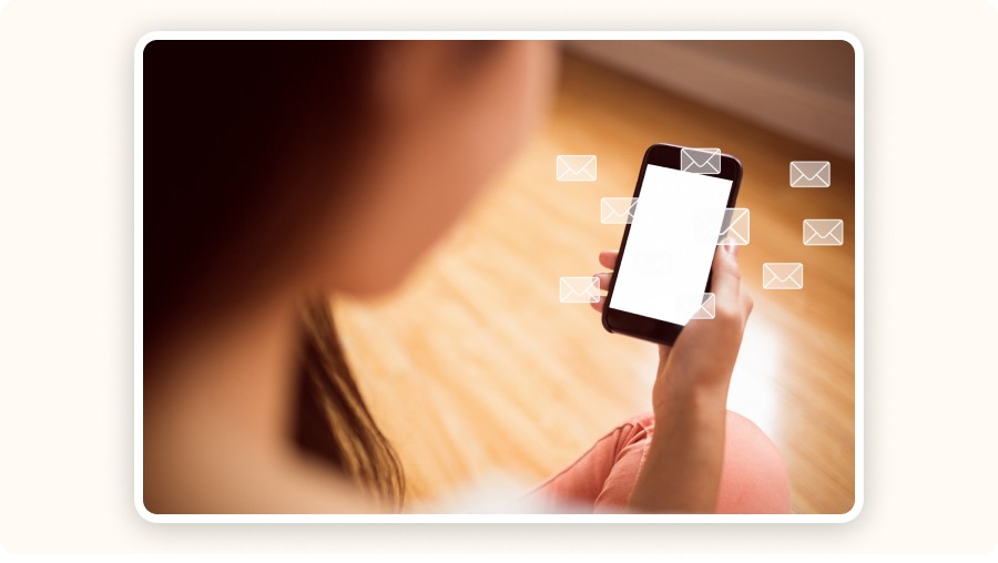 Person holding smartphone receiving multiple email notifications on screen