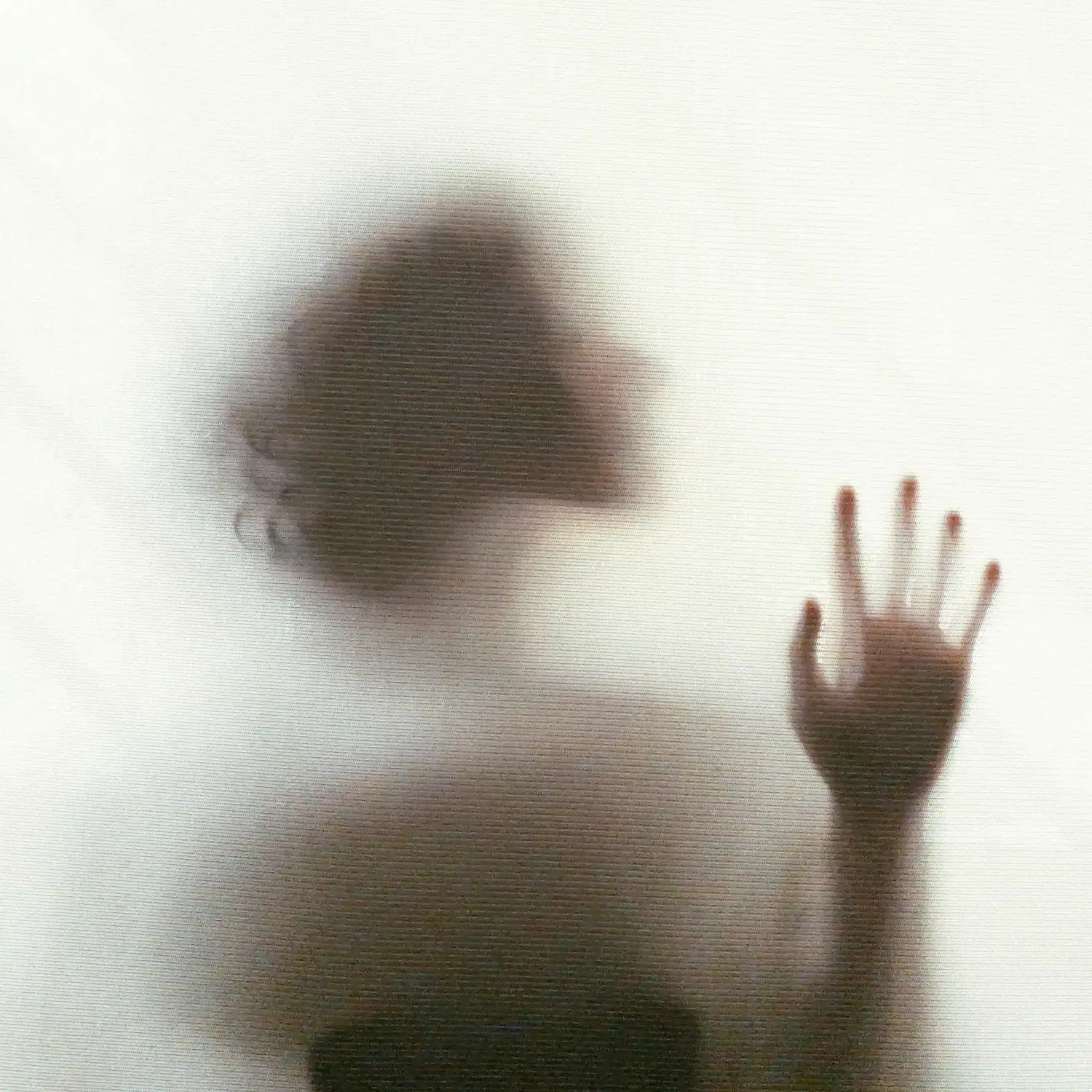 Silhouetted person behind frosted glass symbolizing vulnerability, identity, and self-discovery through sexuality exploration therapy in Los Angeles.