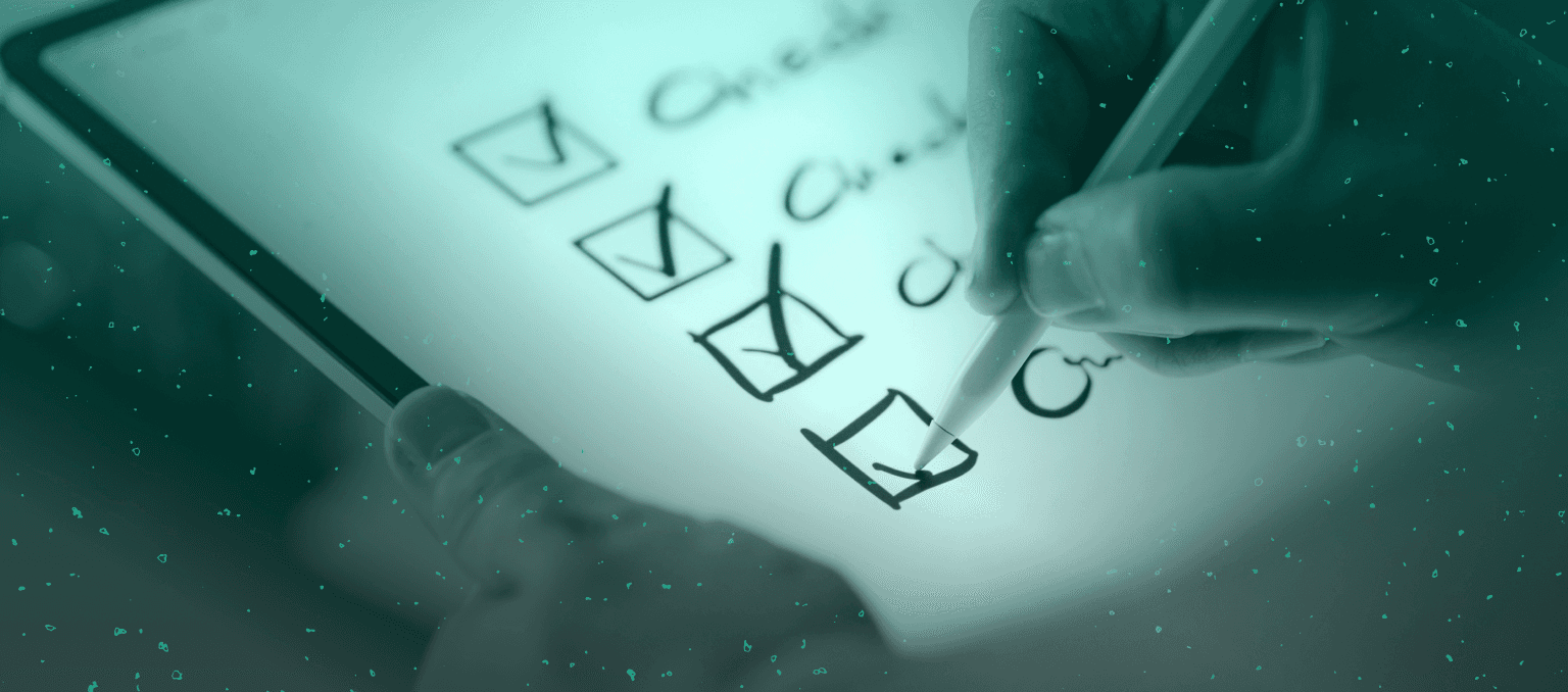 Lifecycle marketer reviewing a checklist on a tablet, symbolizing audits, performance reviews, and optimization processes in lifecycle marketing strategy.