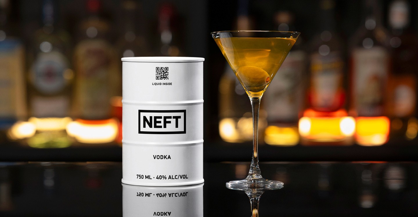 A NEFT Barrel and a glass of Dirty Martini on a bar counter.