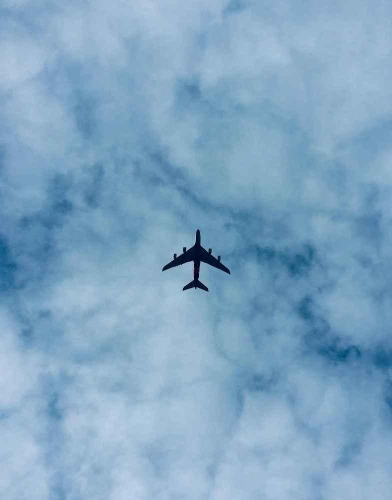 Aircraft in flight representing the firm's cross-border advisory reach across Europe