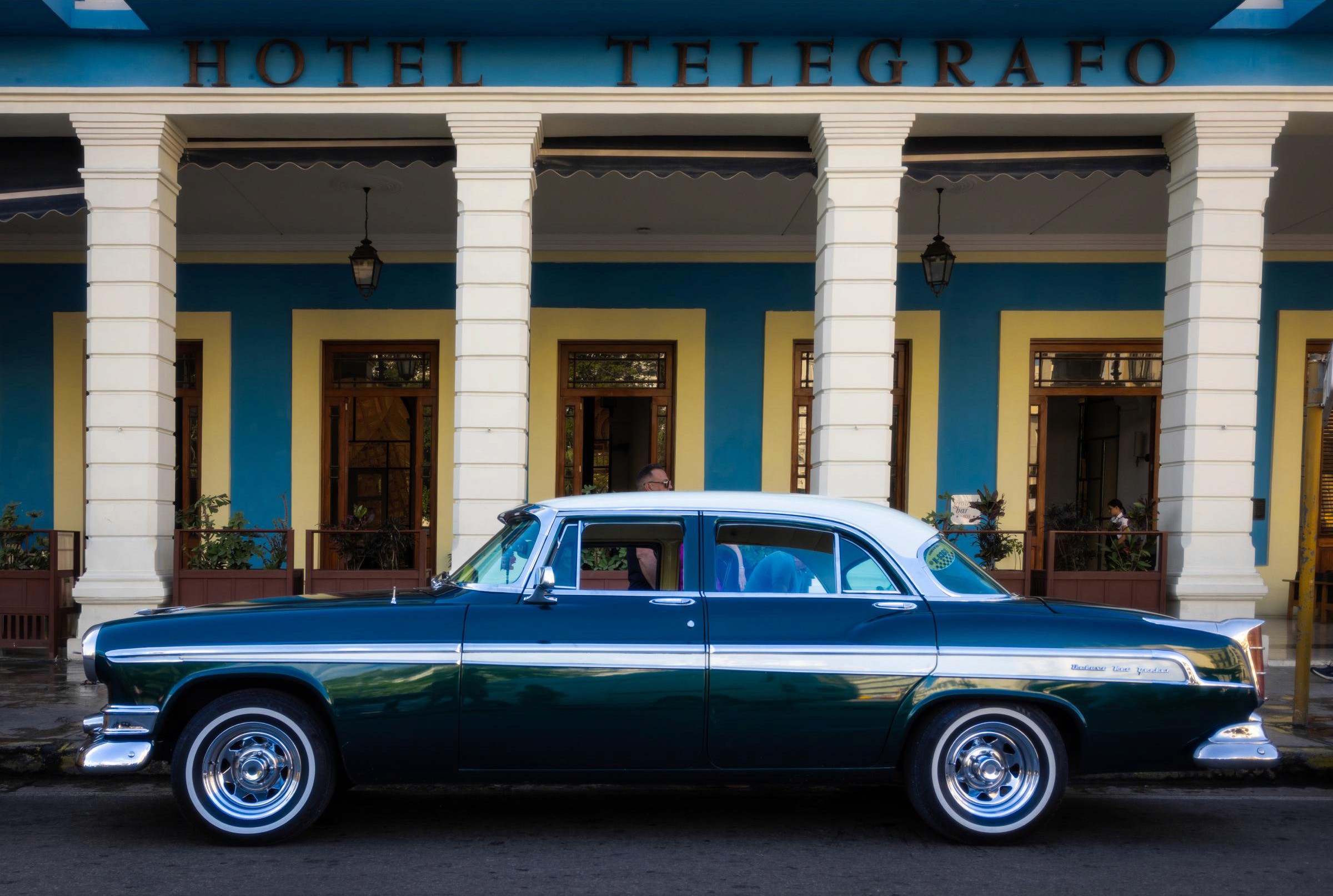 1955 Chrysler New Yorker sits parked regally in front of Hotel Telegrafo