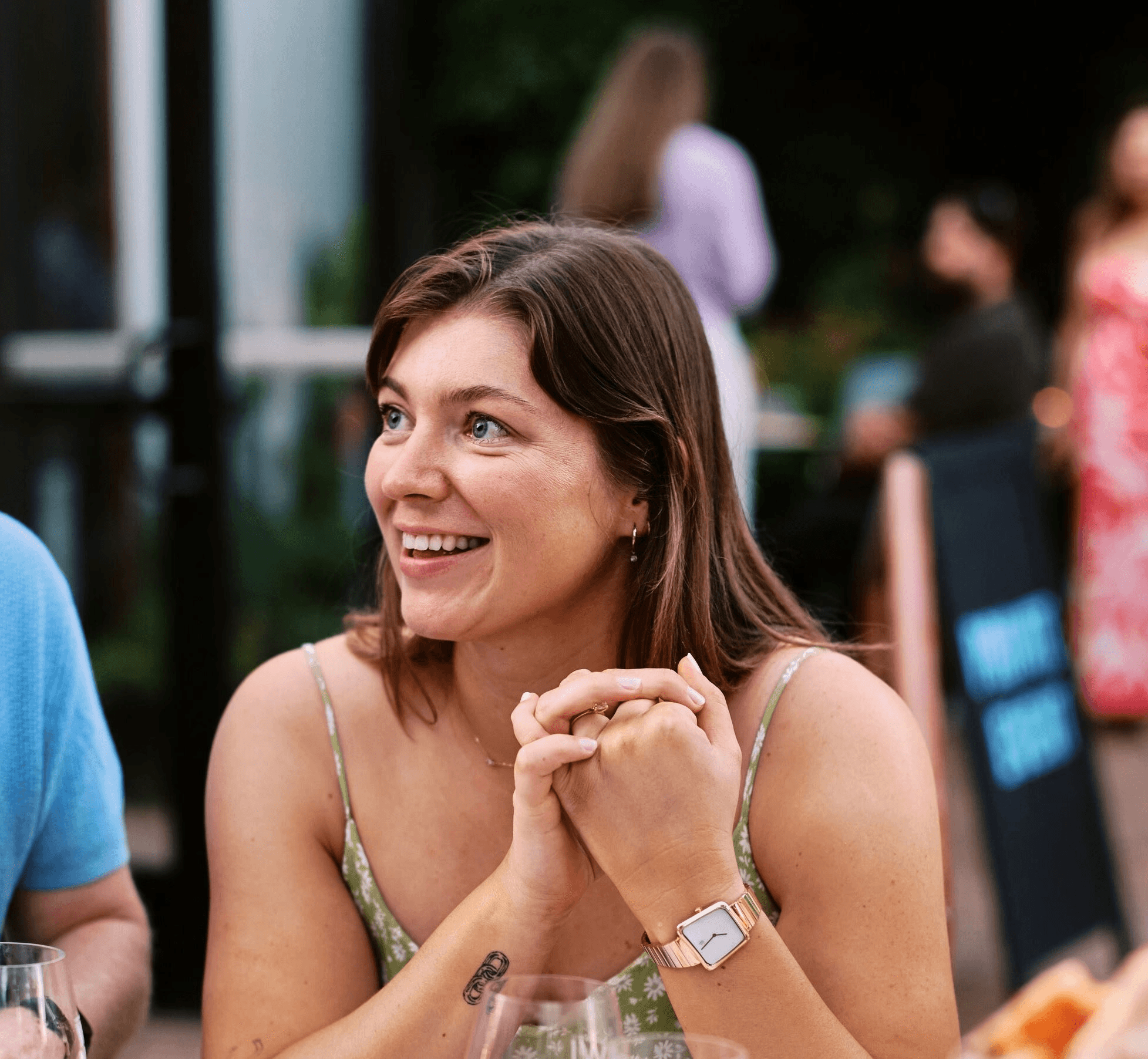 A thoughtful young person with dark hair gazes to the side, captured in soft black and white lighting.