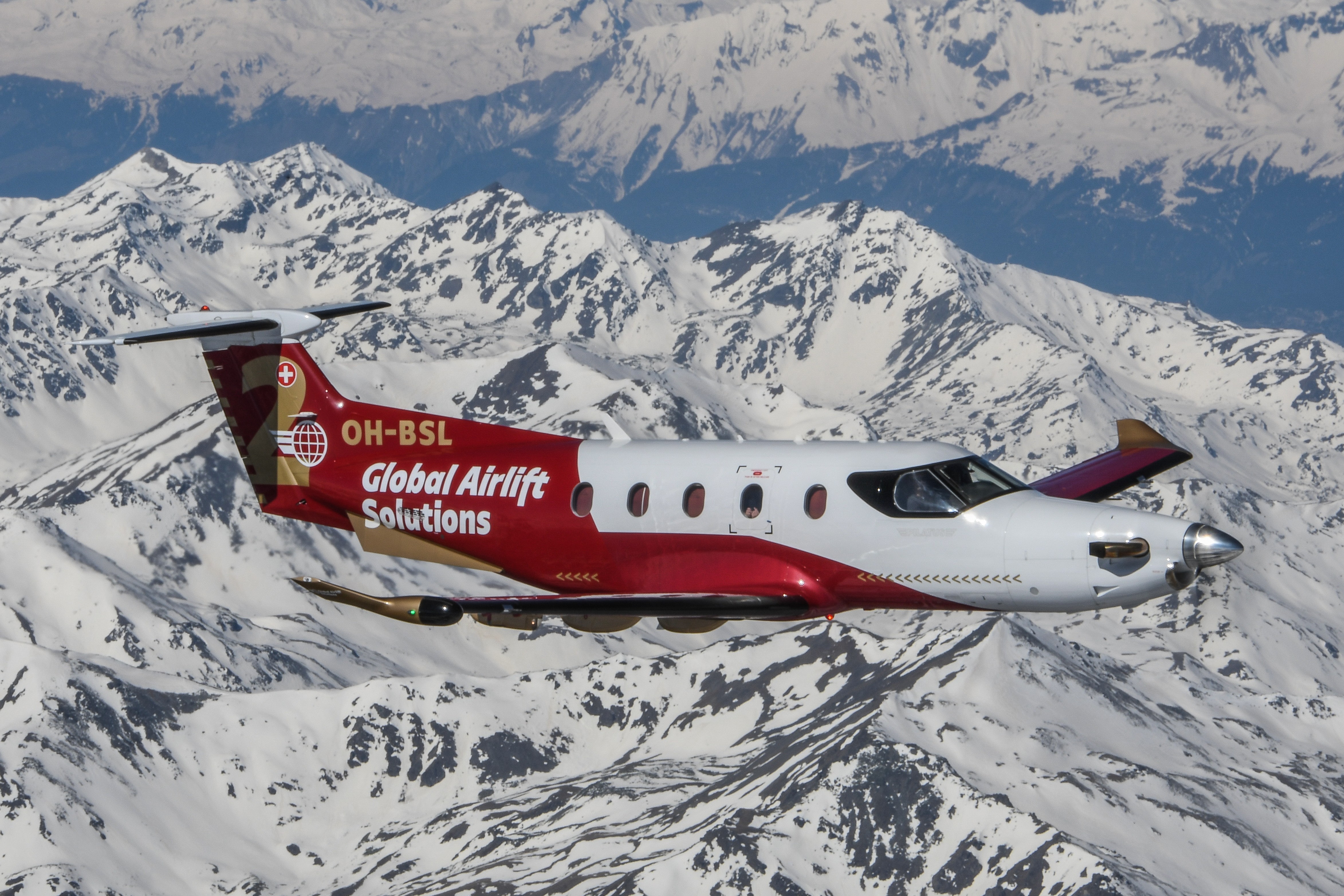 Pilatus PC-12 flying over snowy mountians