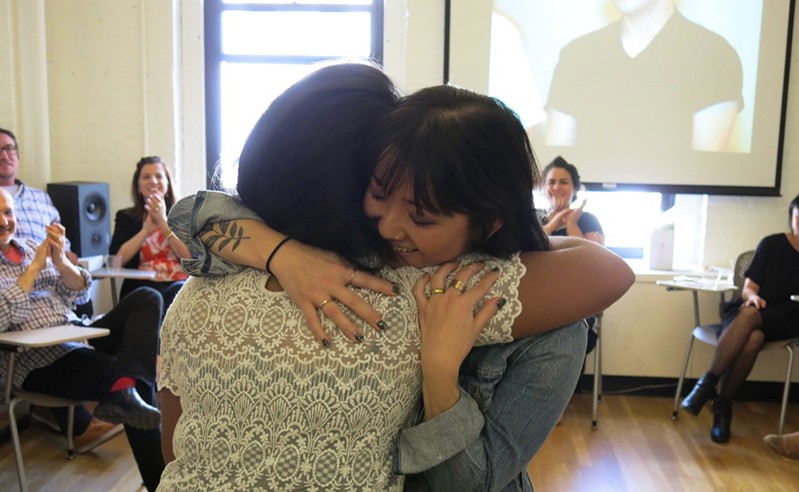 close photo of two persons hugging
