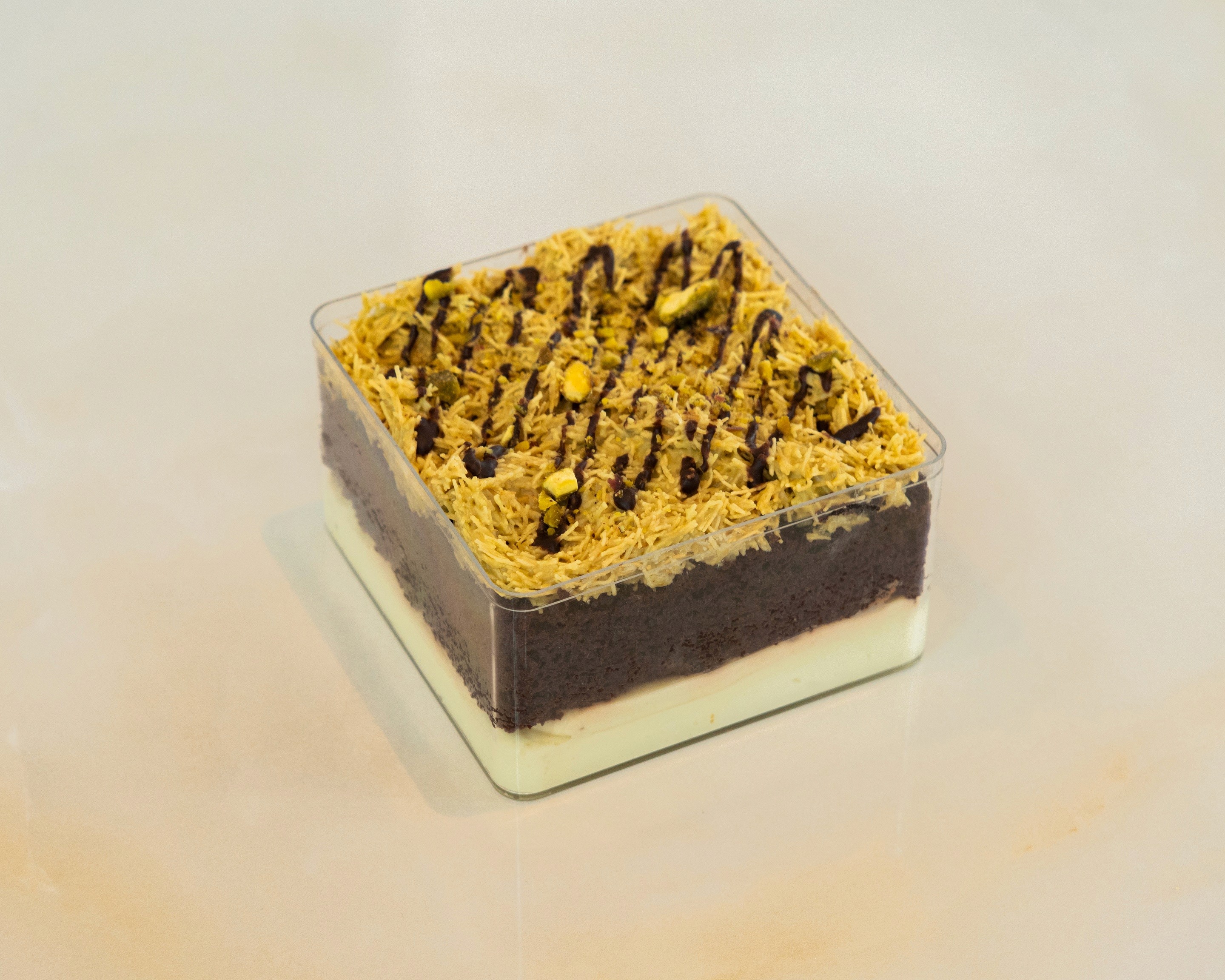 Square chocolate dessert with cream layer and chocolate drizzle at TruLe Yours Cafe Seattle