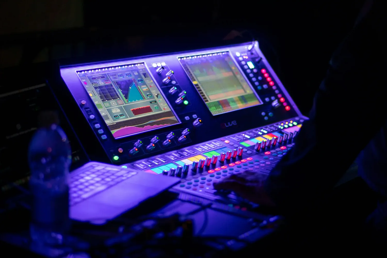 Someone is operating a sound mixing console.