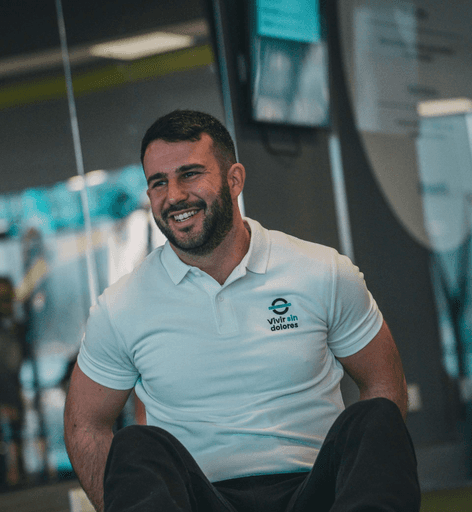 A cheerful man in a white shirt seated on gym equipment. Text: Tyler Bennett – Nutritionist.