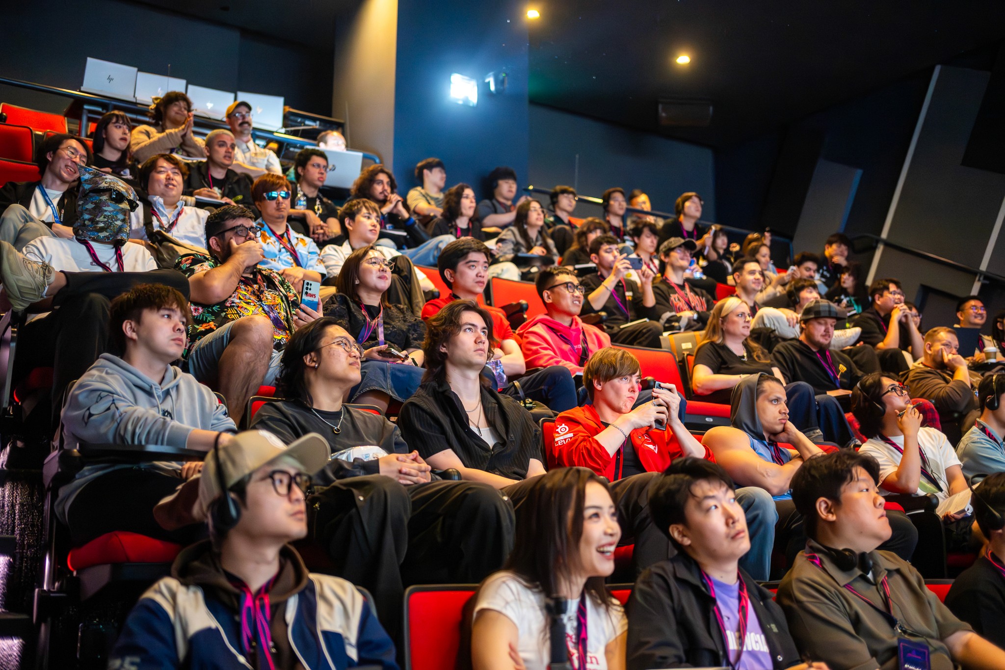 A wide shot of the venue showing the impressive lighting and crowd during a presentation.