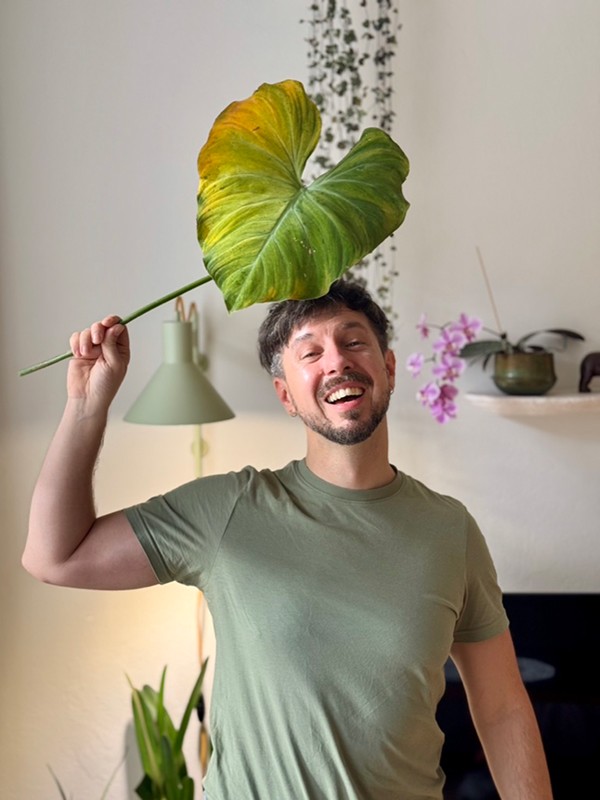 Matt Slow with a tropical plant from his houseplant collection
