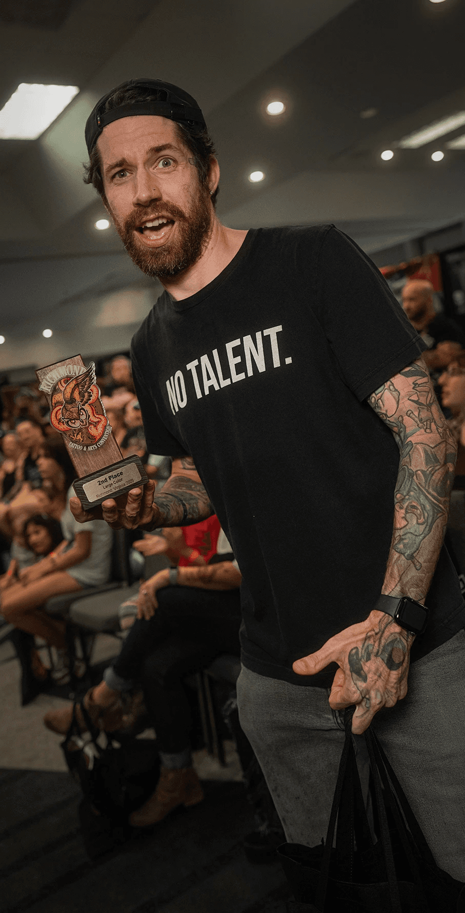 Photo of Chris Jenkins winning a trophy at the richmond tattoo and arts convention in 2025