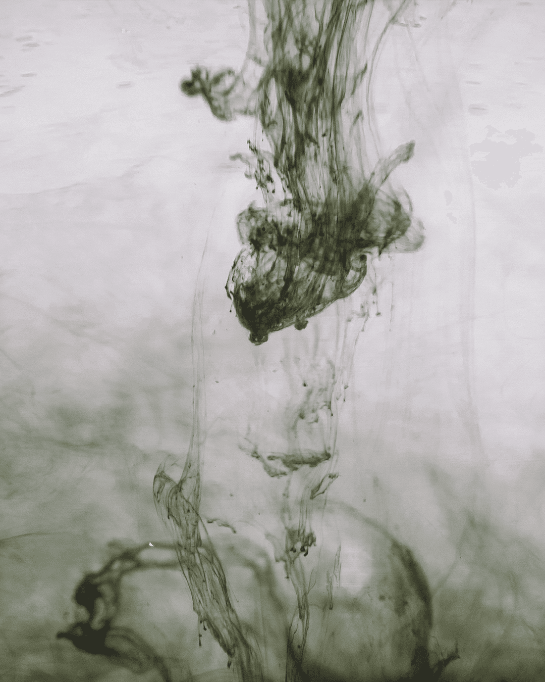 A plaster hand sculpture in focus while two people chat in the background