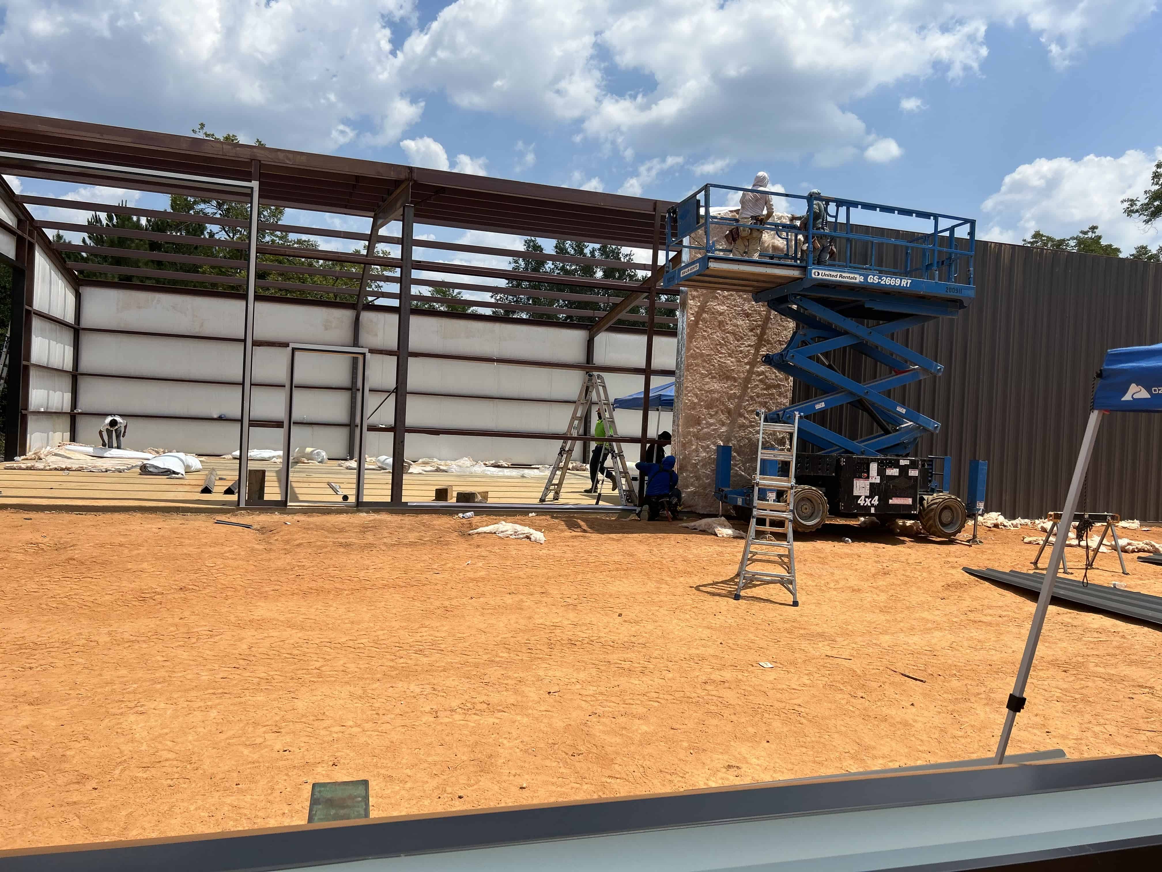 This is a photo of the manlift used to fabricate and install the PEMB metal dealership building.  MIG and stick welding services were used to complete this metal building in Henderson, Texas.