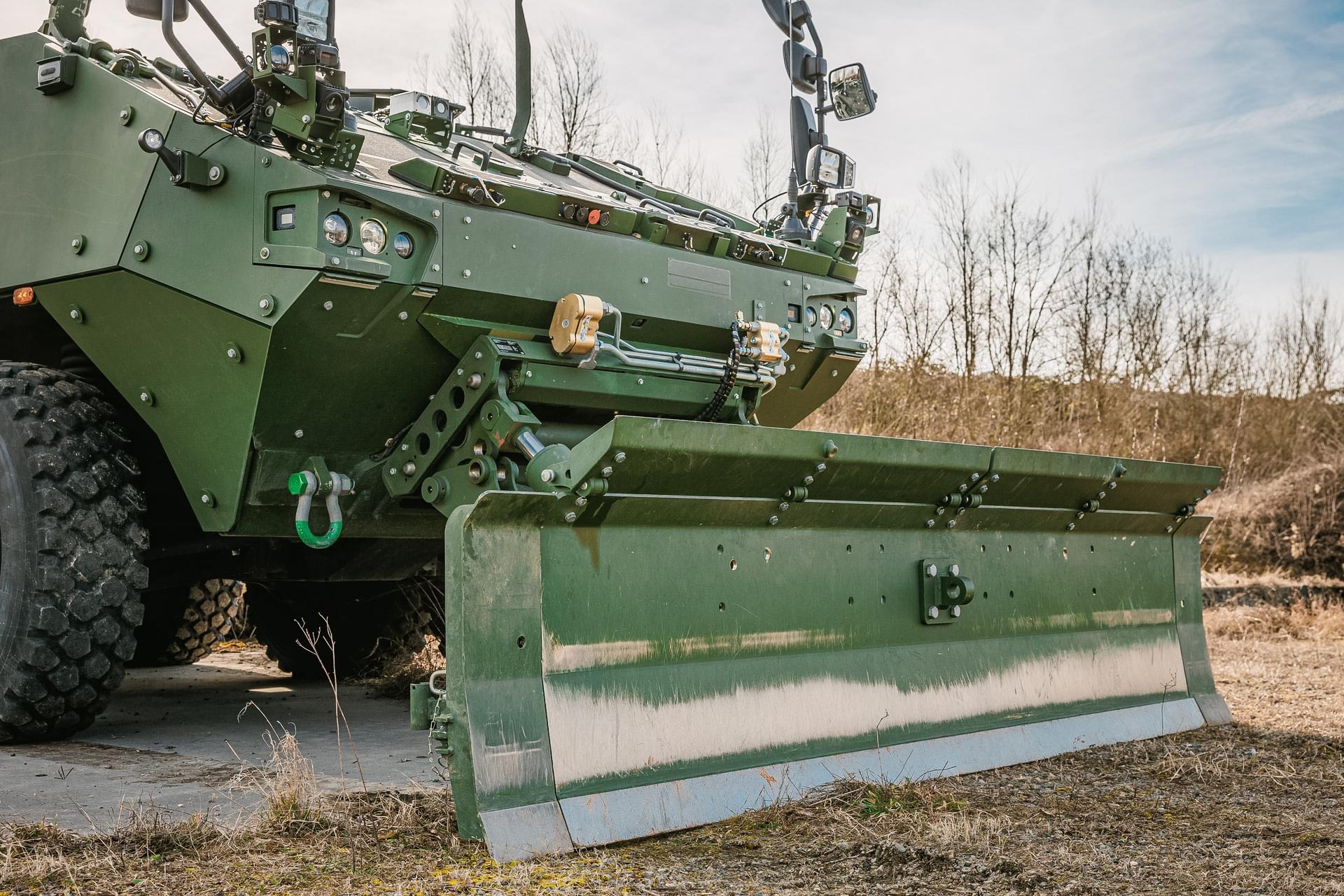 Close-up of GCS Dozer Blade attachment mounted on a Piranha IV wheeled armoured vehicle for combat engineering operations.