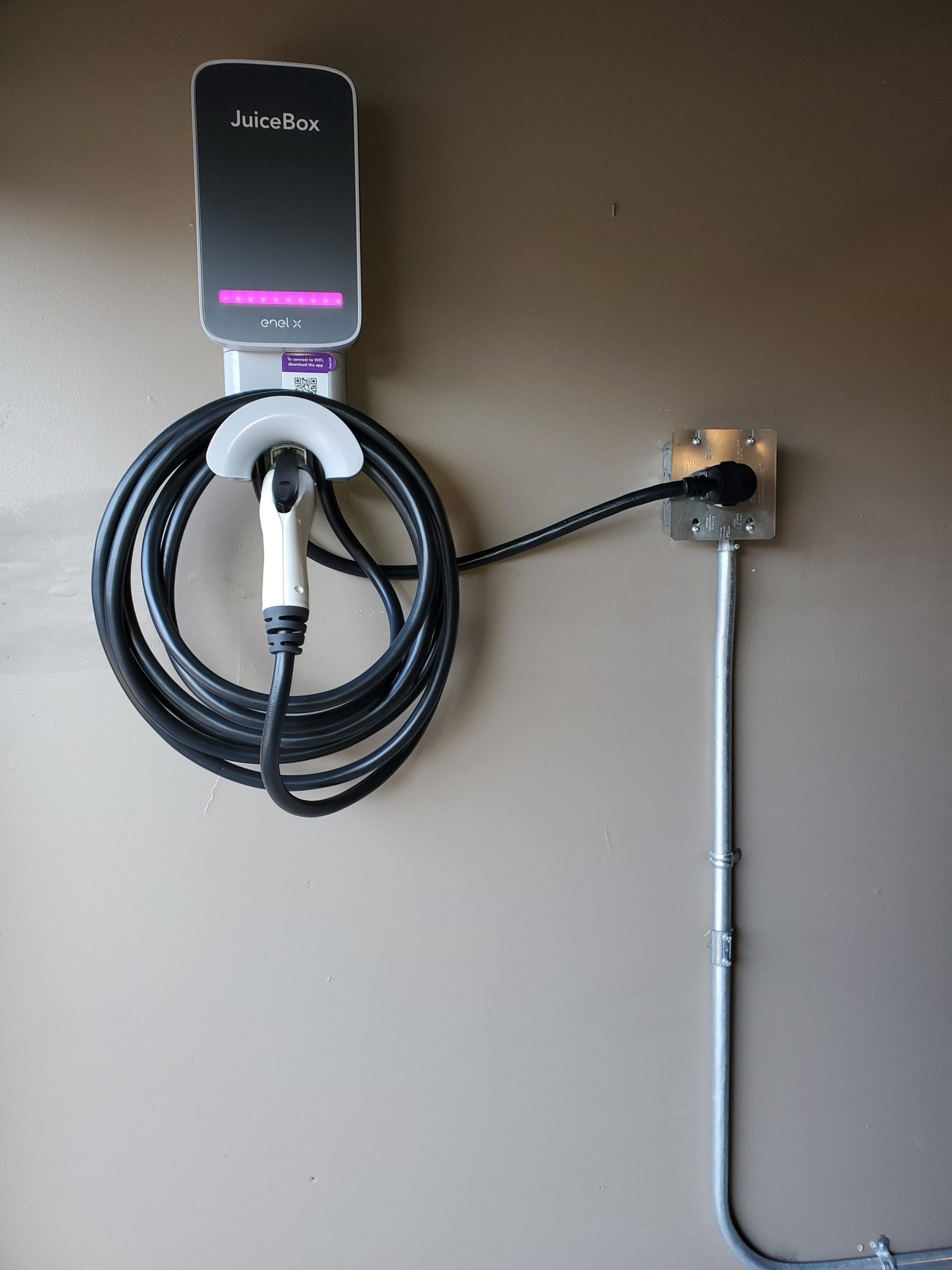 JuiceBox Level 2 EV charger installed on a garage wall