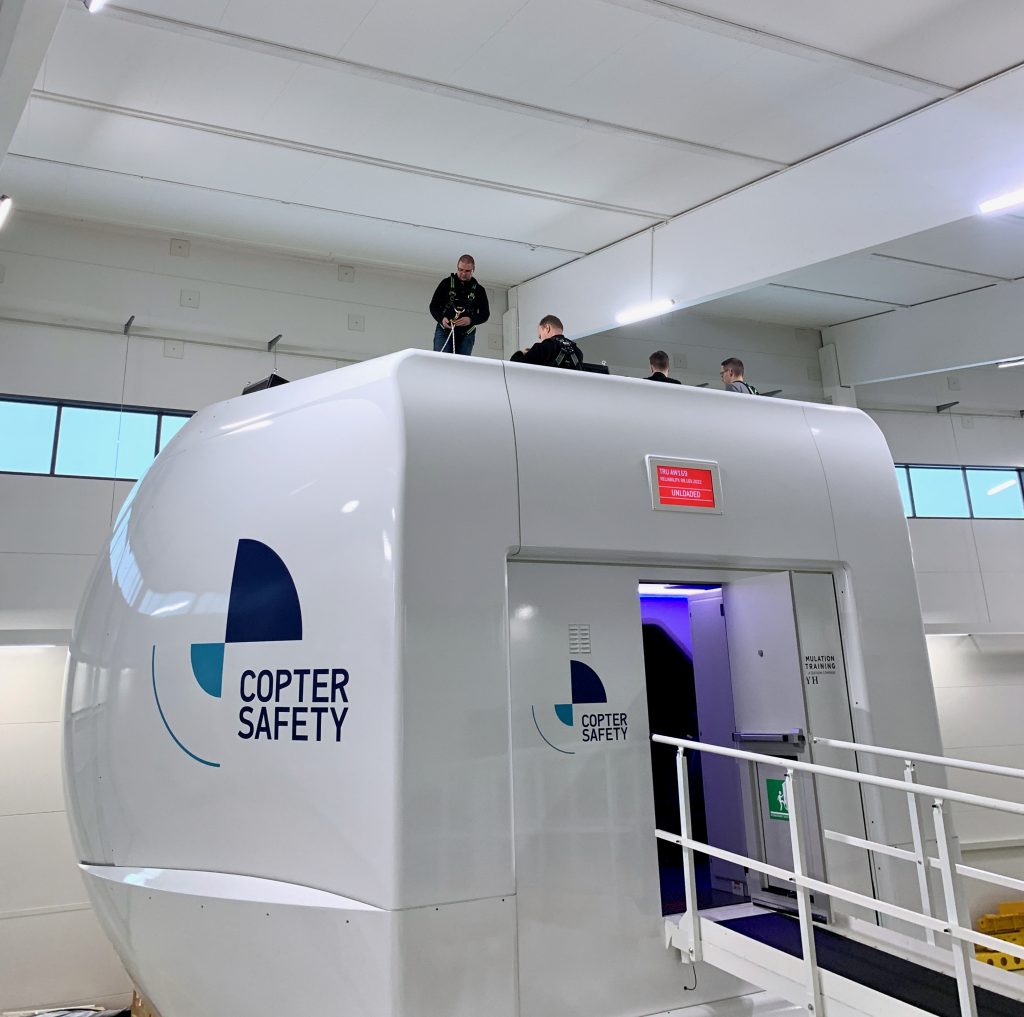 View from below the simulator and the maintenance team with the safety instructor