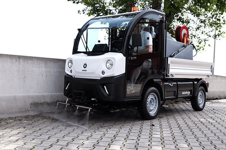 Two wooden huts stand with mountainous views.