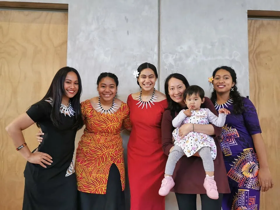 four person holding each others waist at daytime