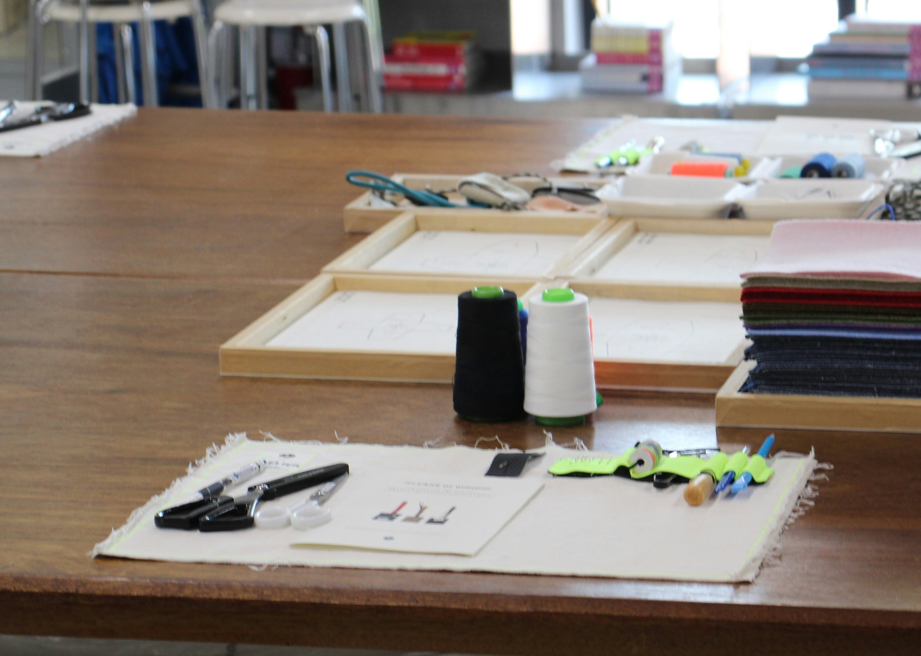 Smiling young man with short hair poses against a dark background, wearing a green button-up shirt.