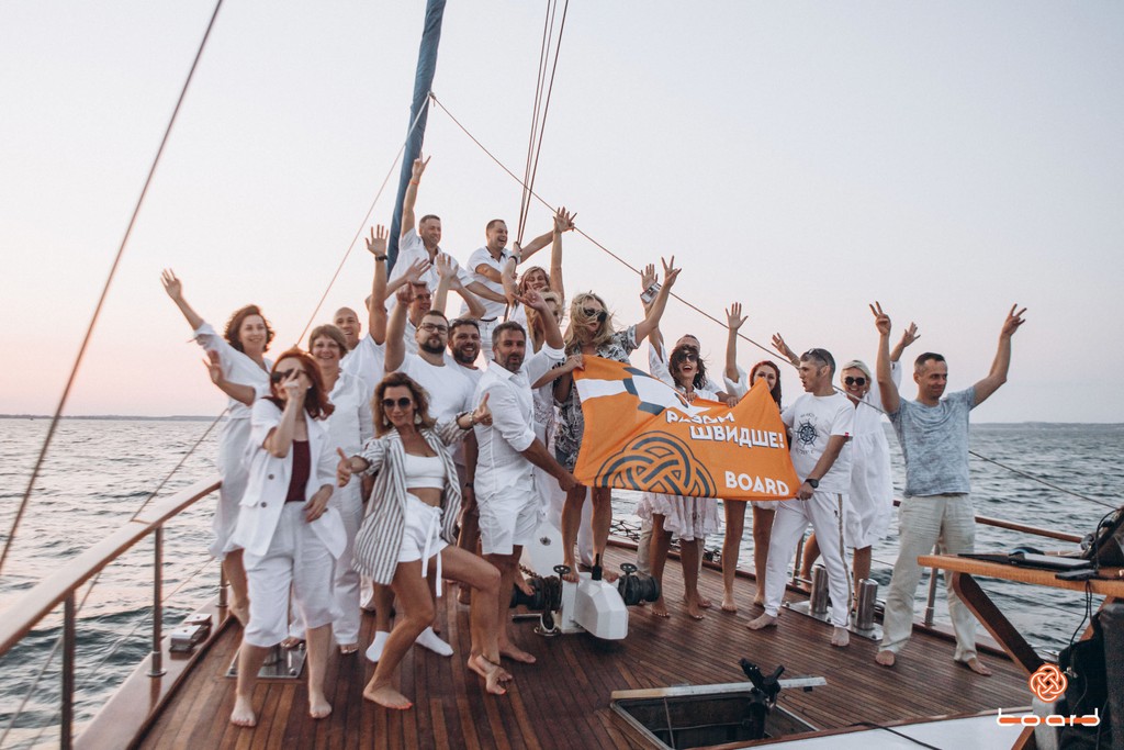 A man stading with Surfboard