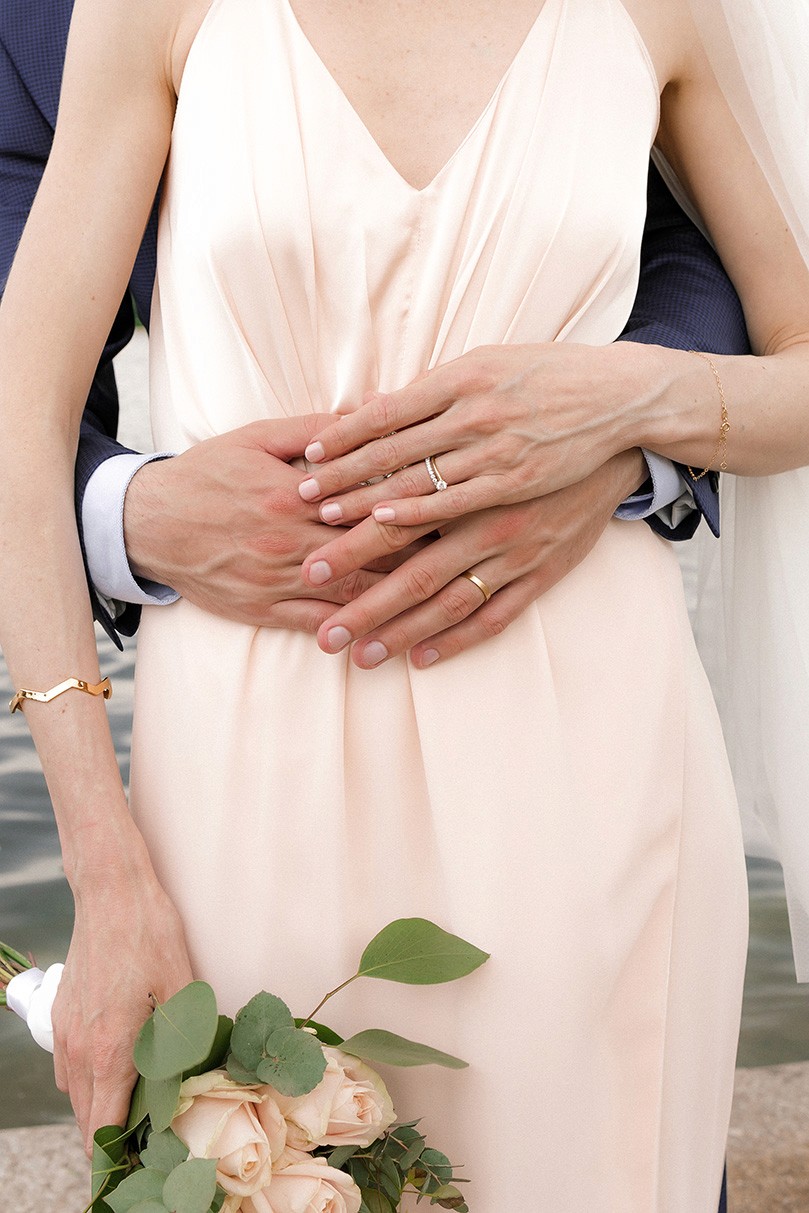 Wedding couple portrait with hands, rings and bouquet details in soft natural light