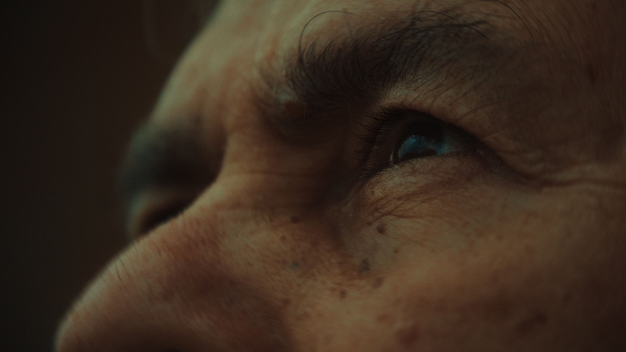 Close-up of an older man’s eyes and weathered skin