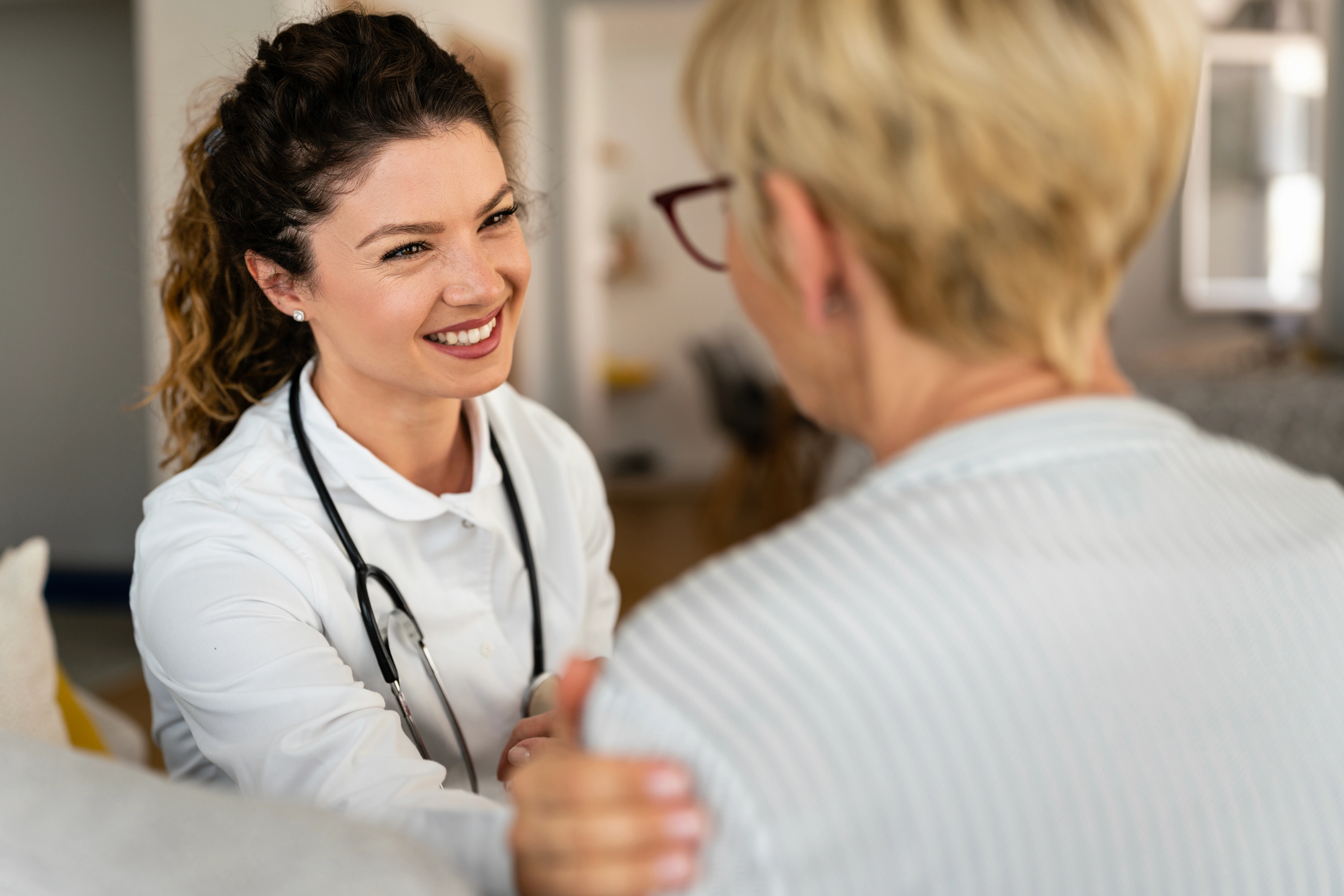 Doctor with patient smiling in office