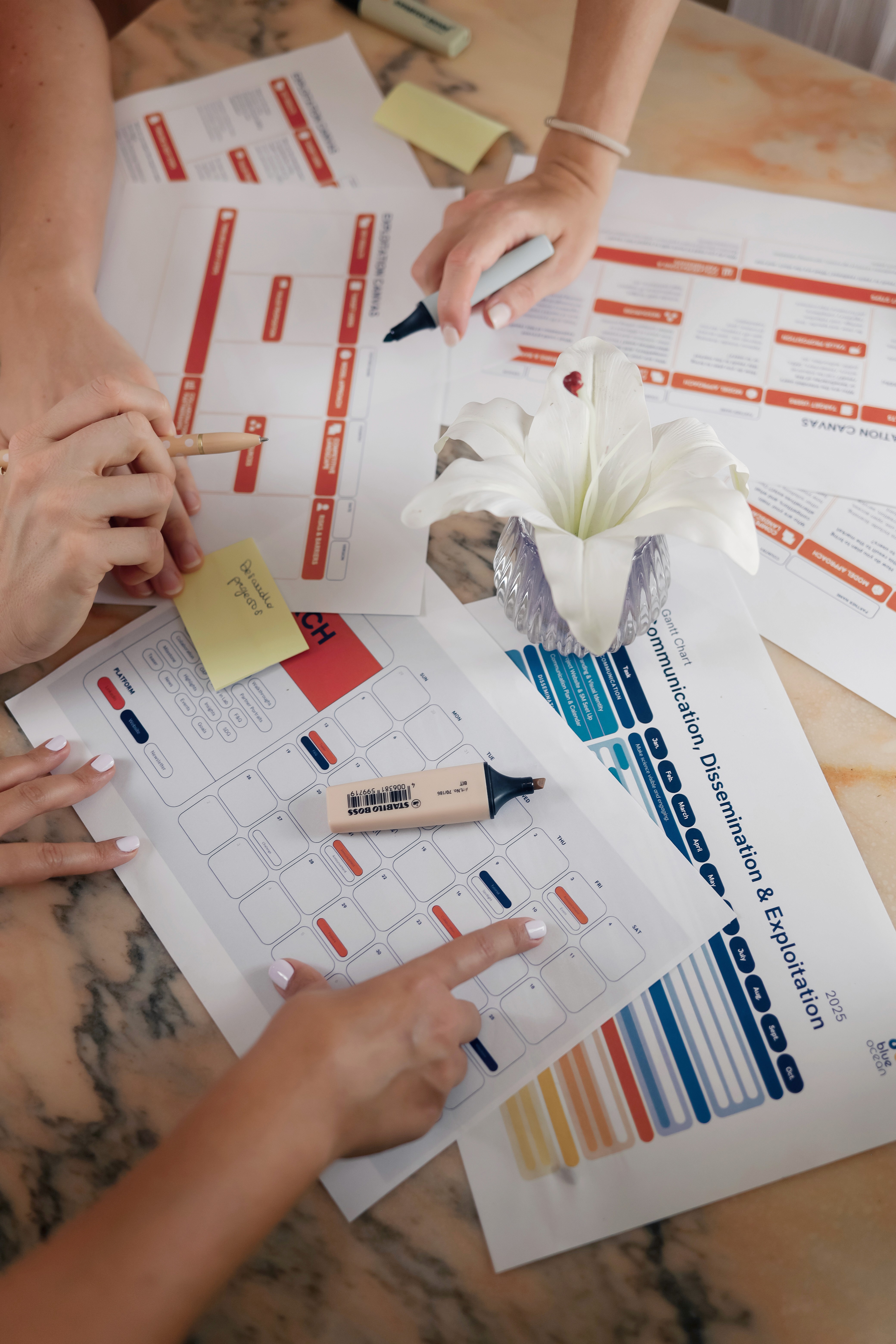 Presenter speaking during a Horizon Europe workshop, standing beside a projected slide on expected outcomes for industrial innovation