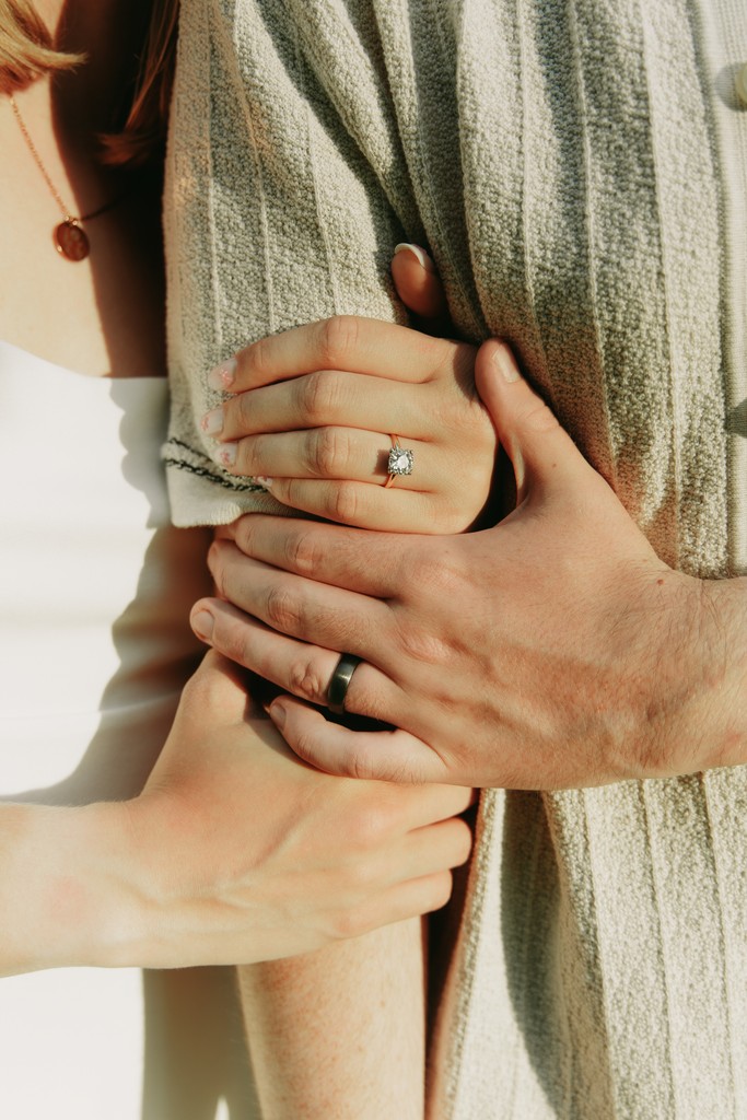 A serene pathway lined with trees leads to a distant building, bathed in warm sunlight.