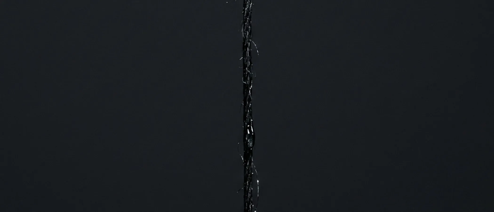 Black fiber with water droplet