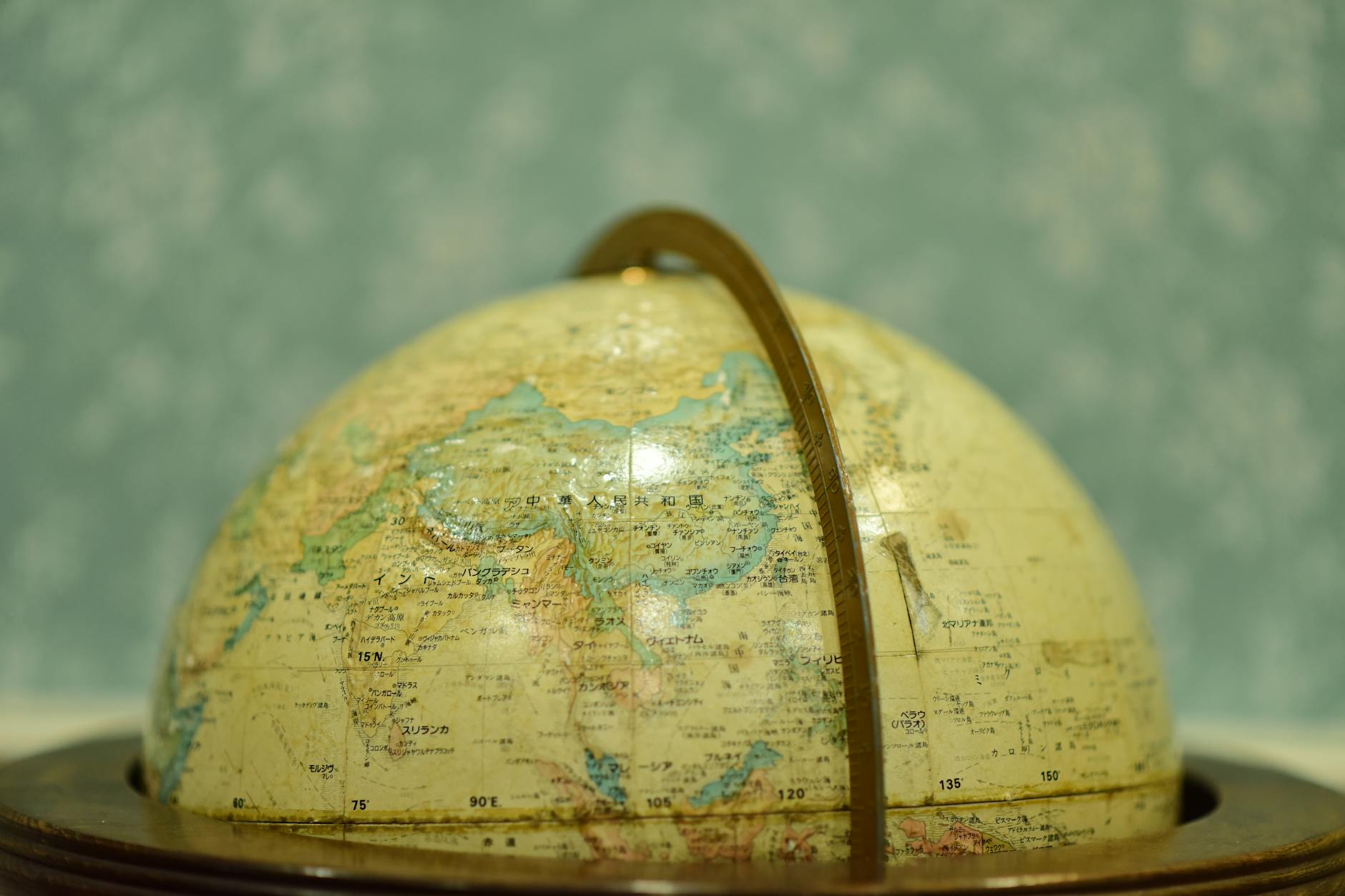 A young girl drawing cold fronts and high-pressure symbols on a large paper weather map.