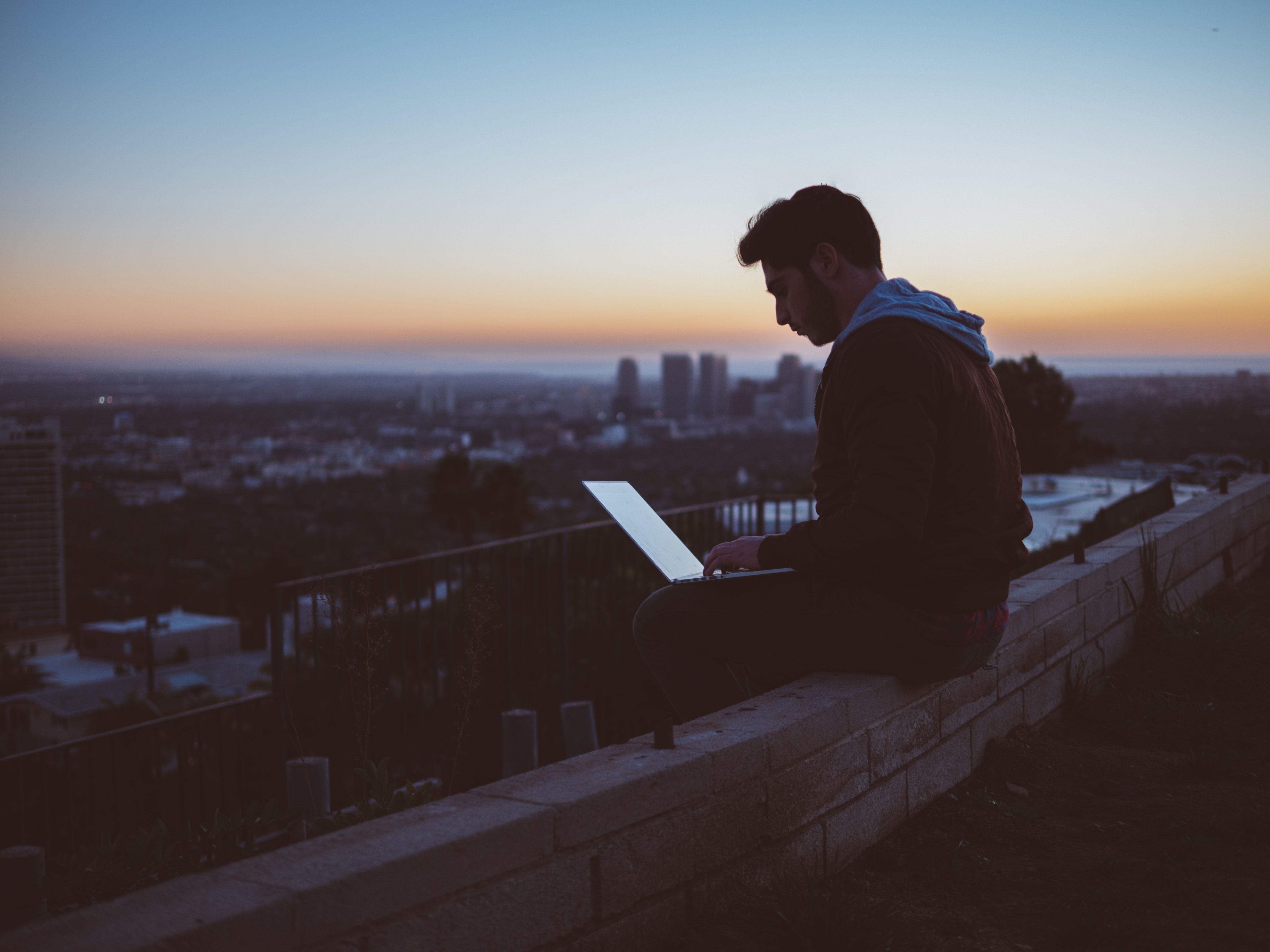 Man editing on a rooftop with a view
