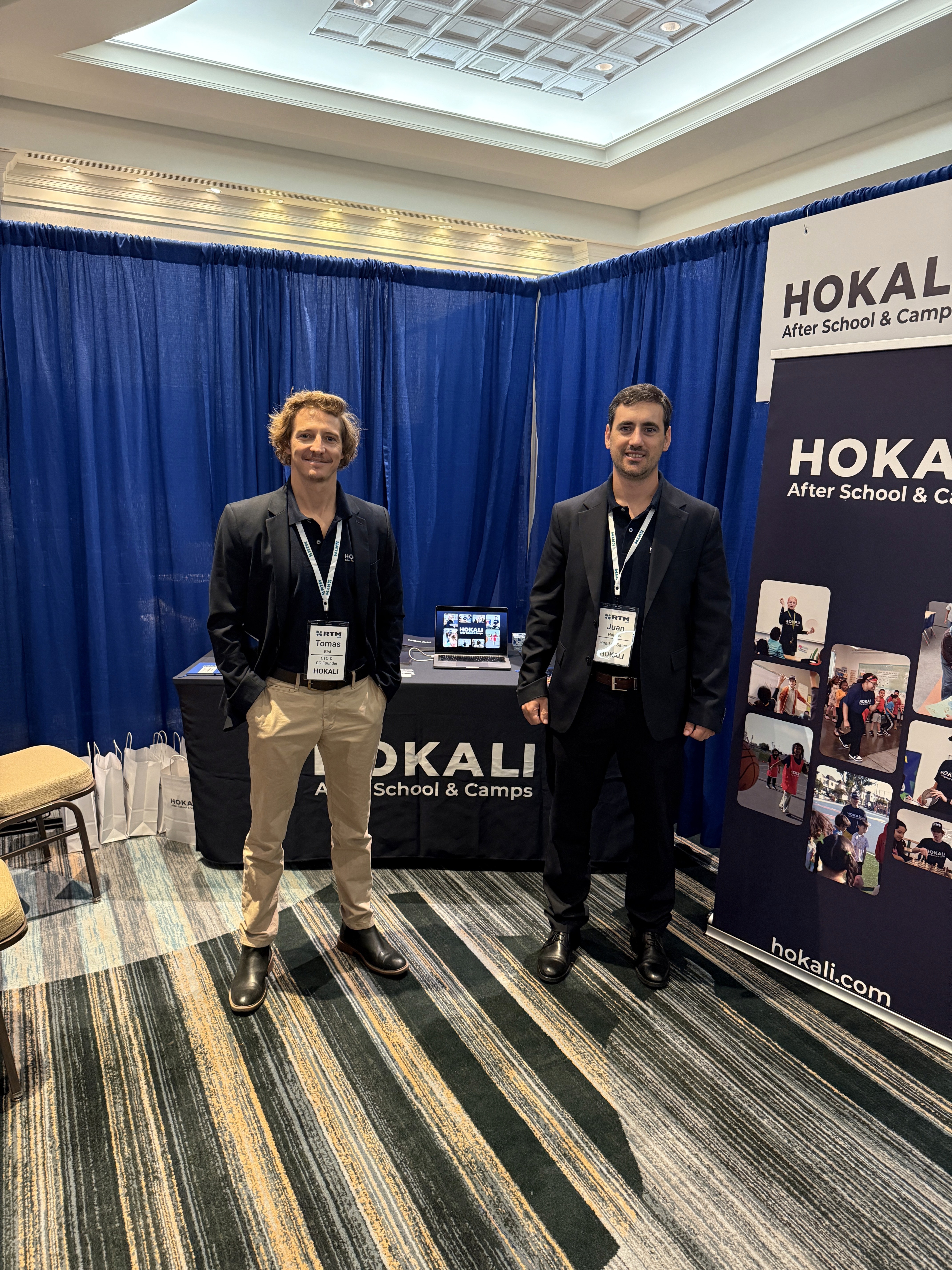 HOKALI team presenting after-school enrichment programs at an RTM education conference booth