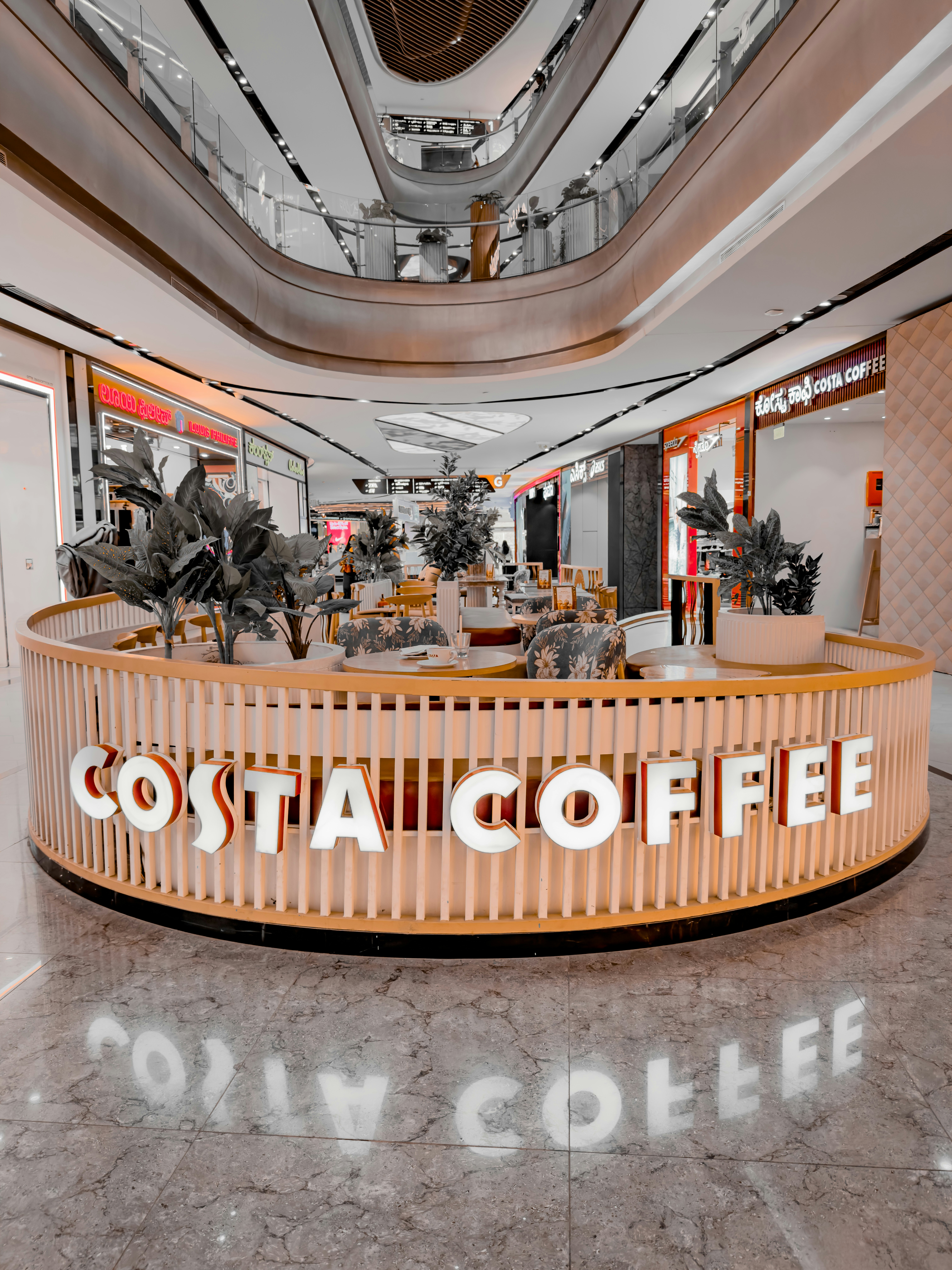Costa coffee shop interior with plants and seating
