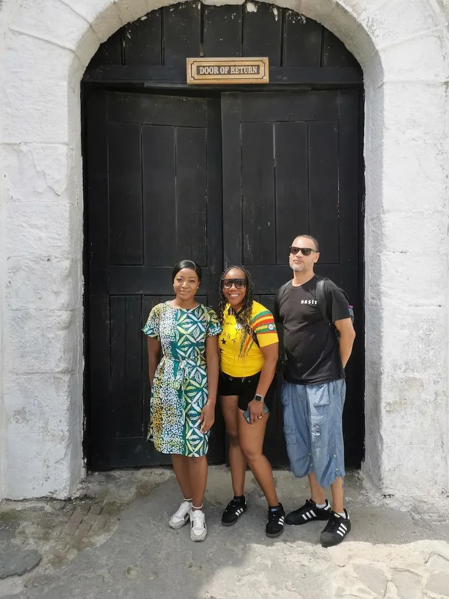 Travelers standing at the Door of Return at Cape Coast Castle.