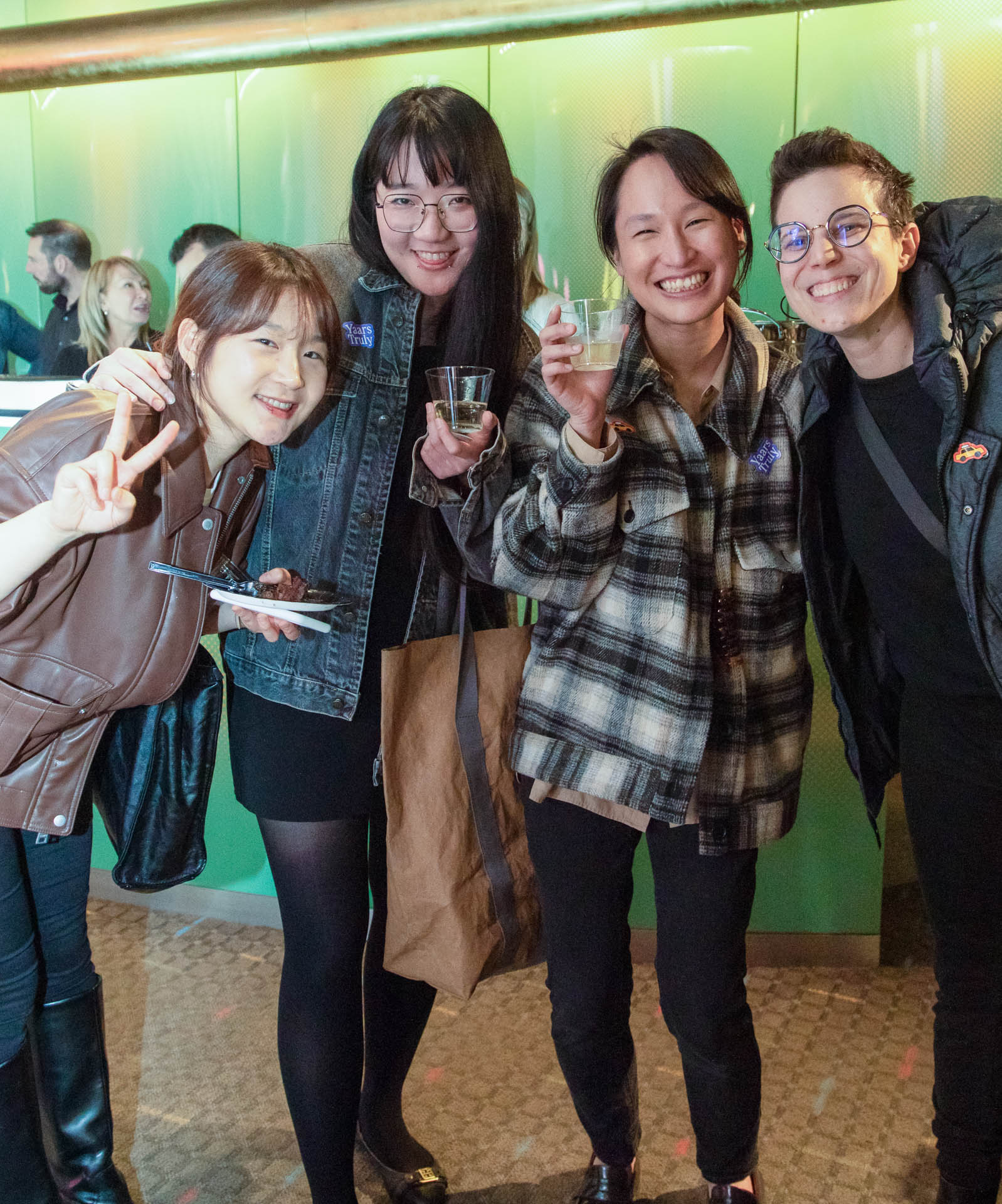 a group of students smiling for the camera in the SVA Theatre lobby after the Venture Forum