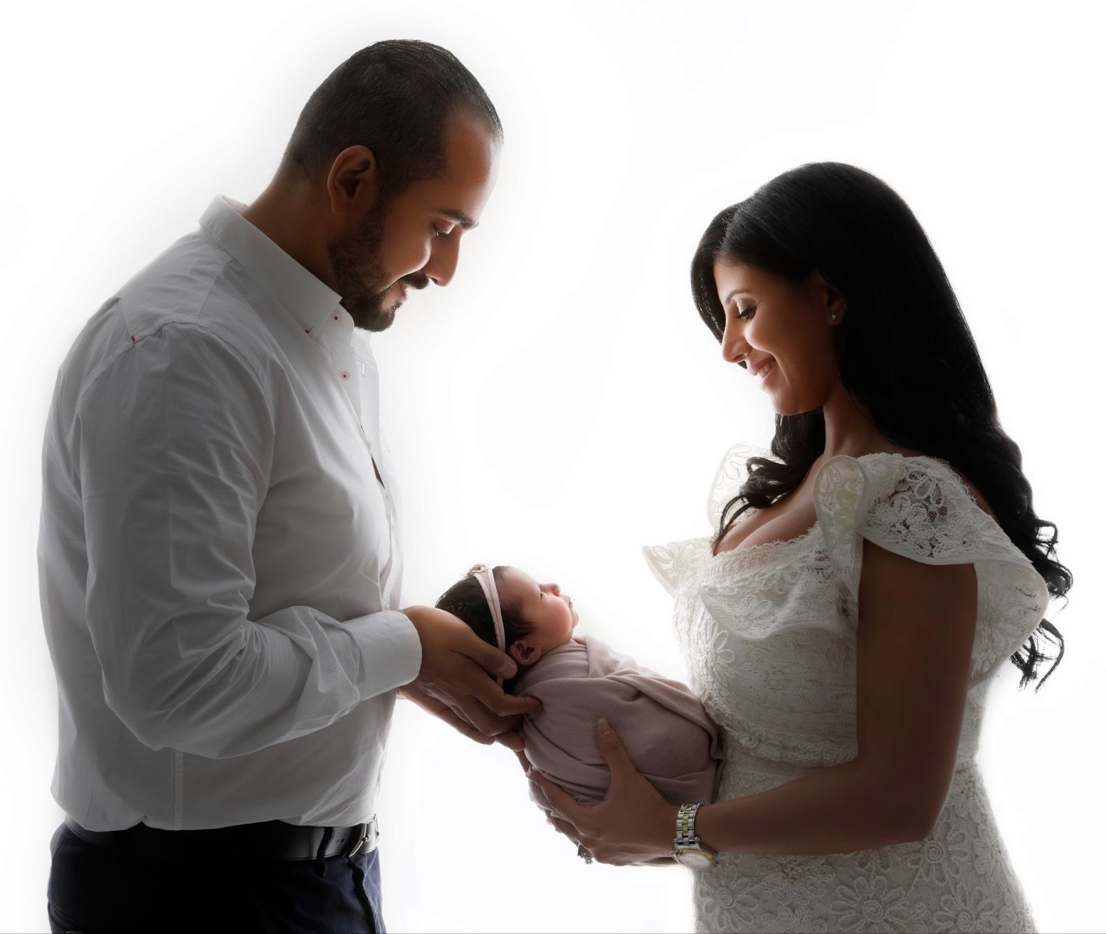 Parents holding newborn positioned using the rule of thirds.