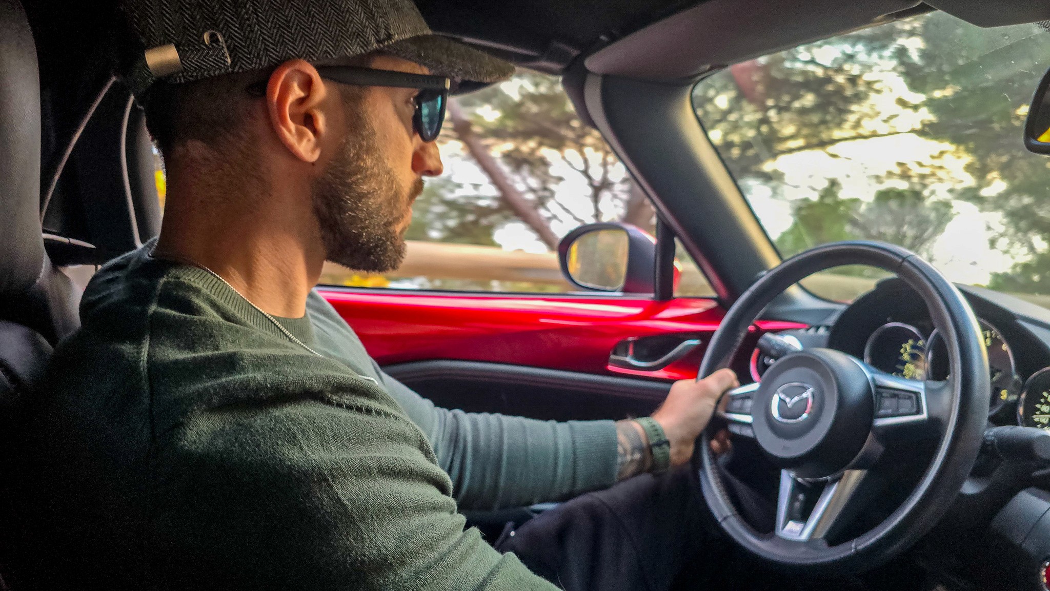 A fast black sports car races down the highway.