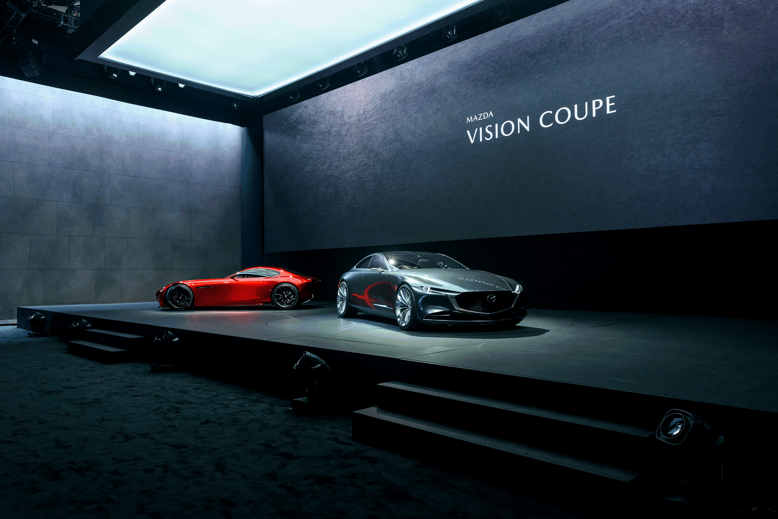 Two Mazda show vehicles on a stage