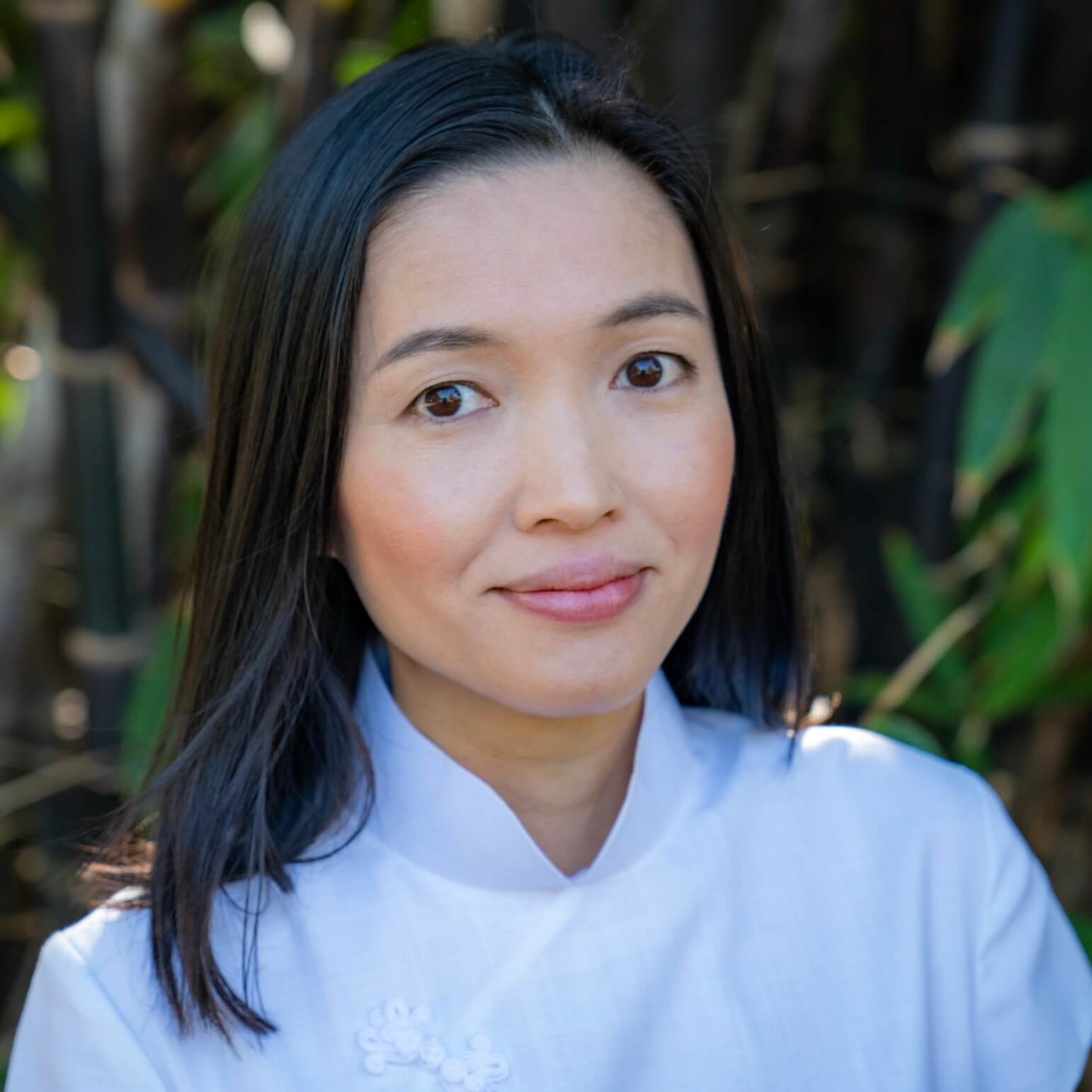 Professional photo of a health practitioner against a background with green plants