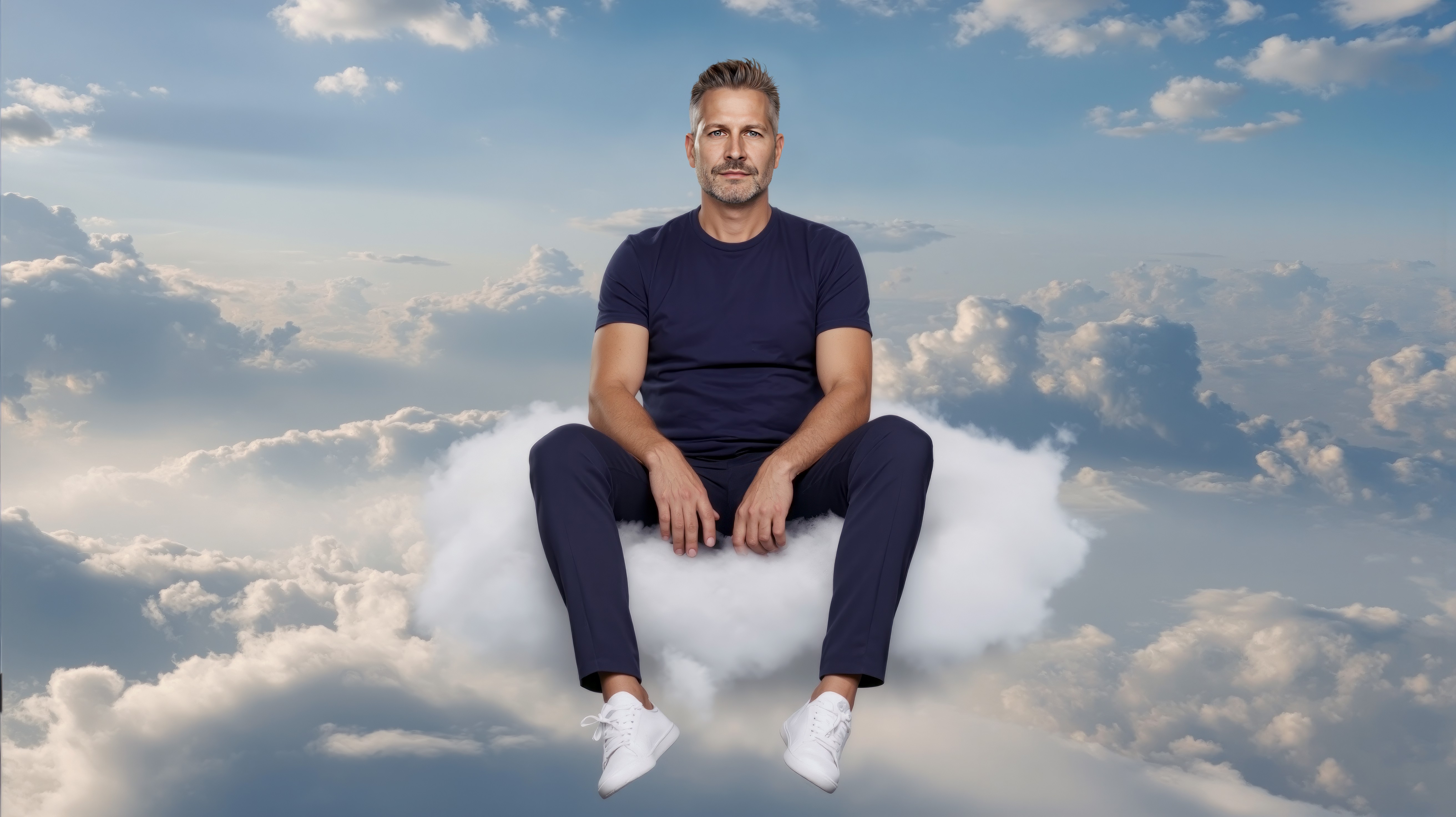 Smiling blonde woman with freckles in a white shirt, arms crossed, minimalist studio portrait.