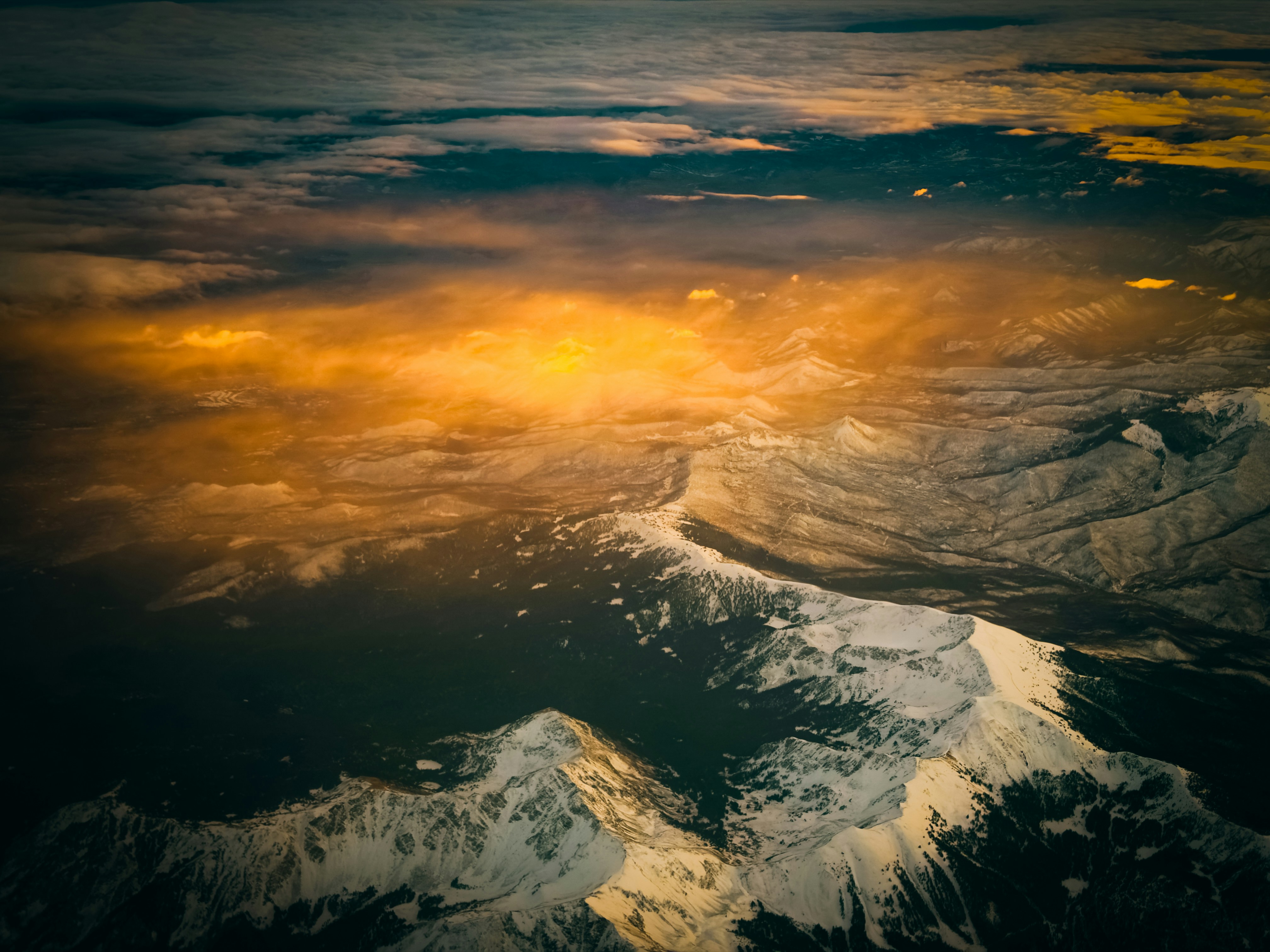 Aerial view of snow-capped mountains at sunset